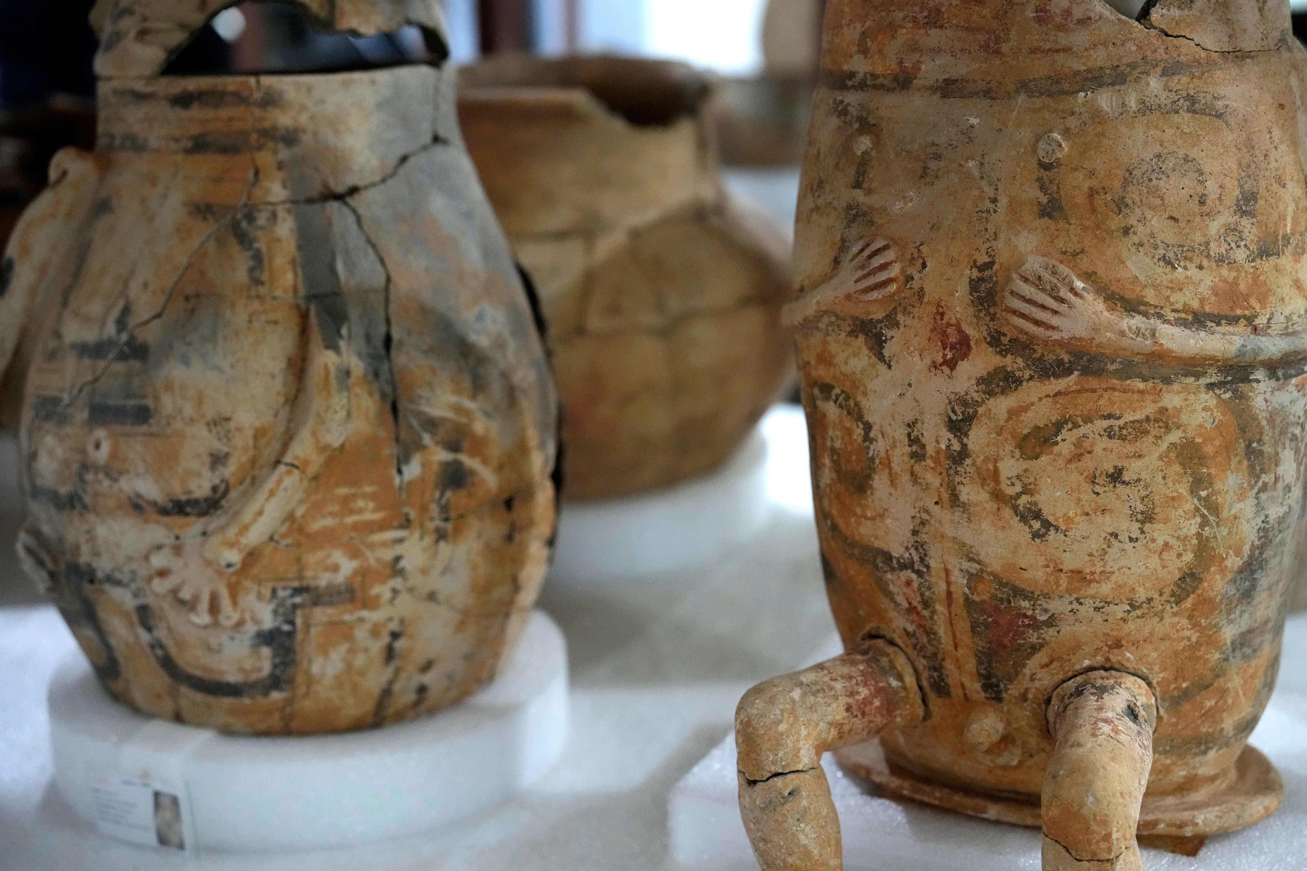 Pottery vessels with anthropomorphic features believed to be urns are displayed at the Institute for Scientific and Technological Research in Macapa, Amapa state, Brazil, Sunday, March 8, 2026. (AP Photo/Eraldo Peres)