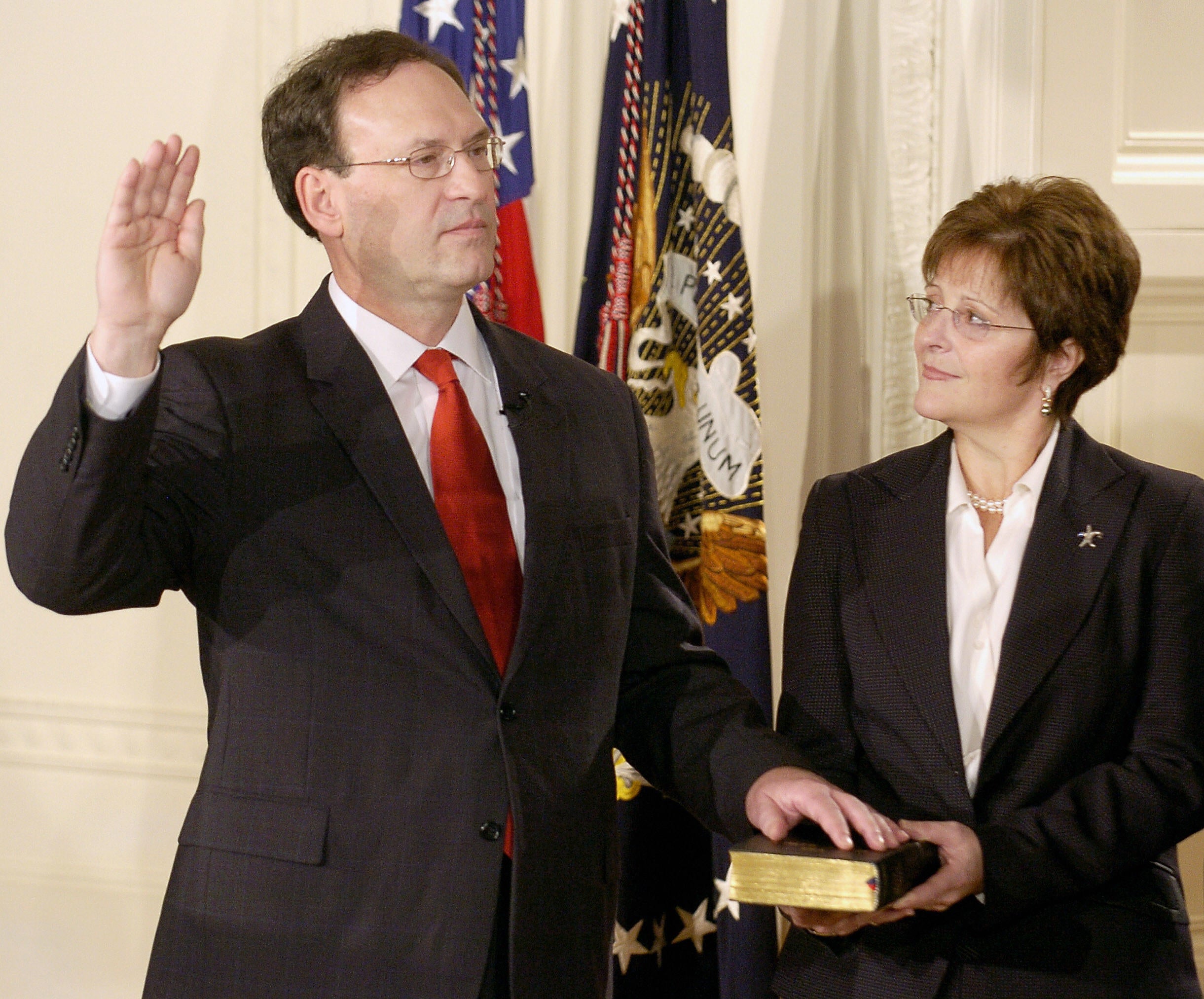 Alito raises his right hand as he participates in a ceremonial swearing-in in the East Room of the White House in Washington in February 2006