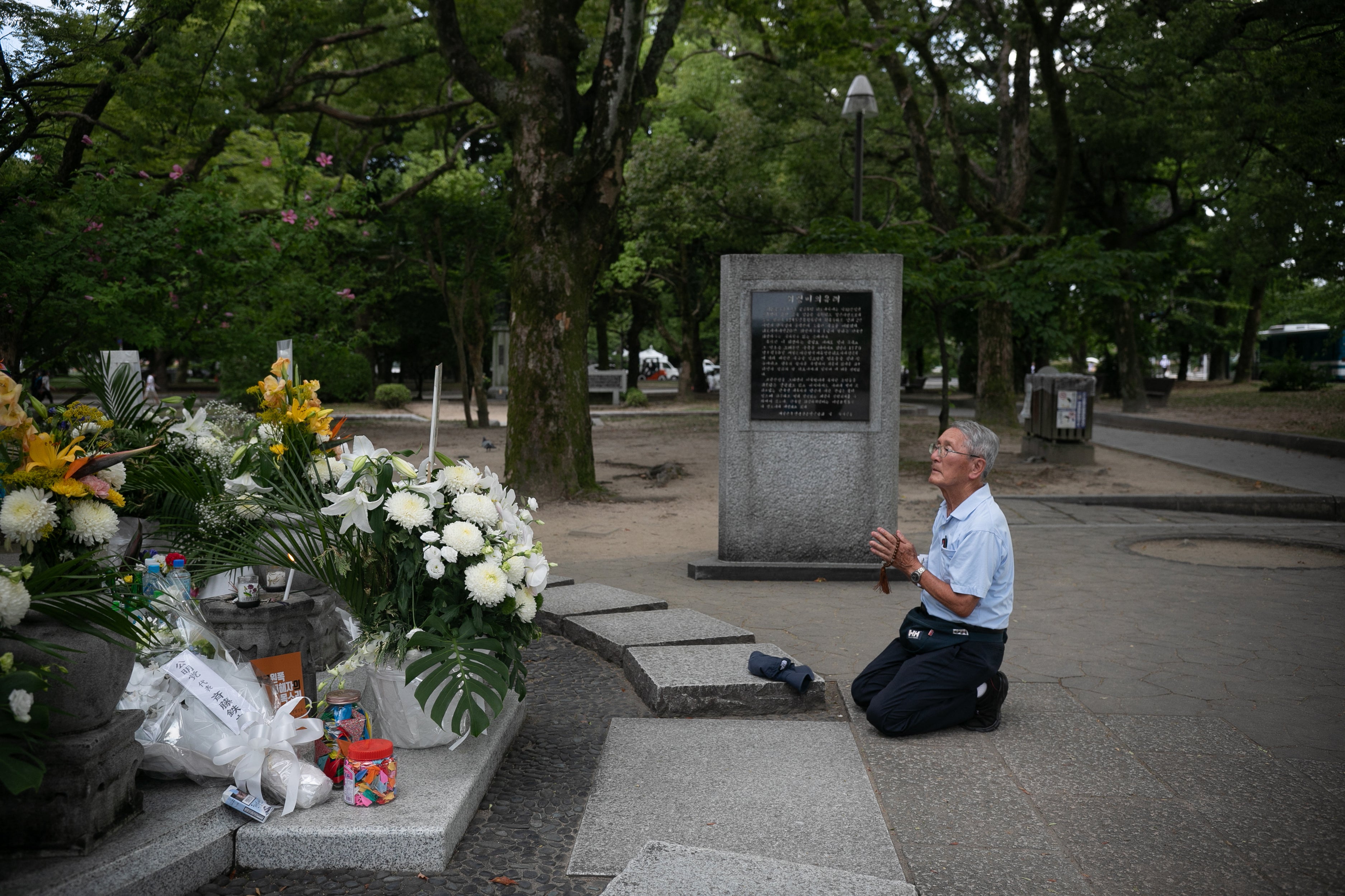 A man prays at the Korean Atomic Bomb Victims Cenotaph inside the Hiroshima Peace Memorial Park