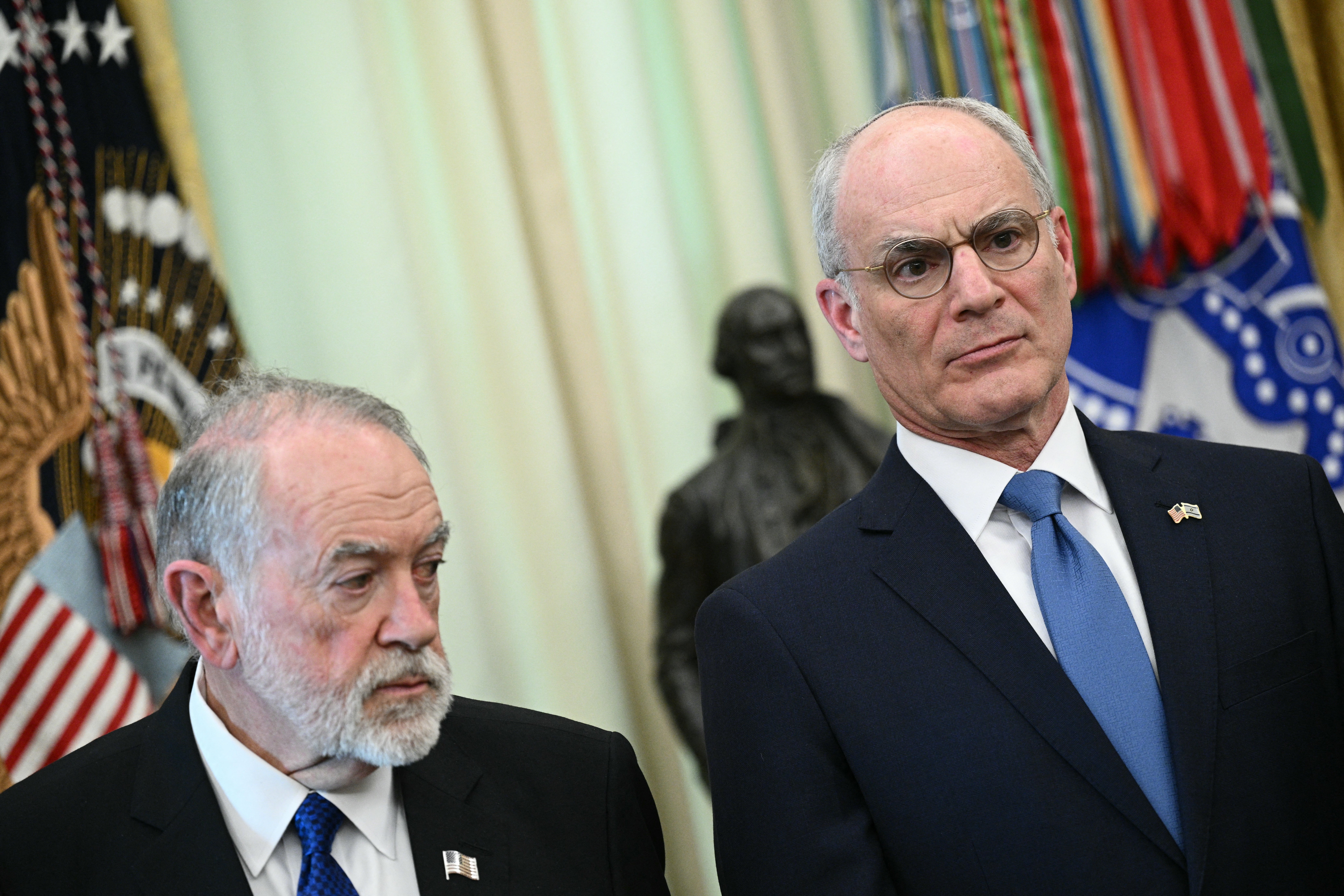 (L-R) US Ambassador to Israel Mike Huckabee and Israel Ambassador to US Yechiel Leiter listen as US President Donald Trump speaks