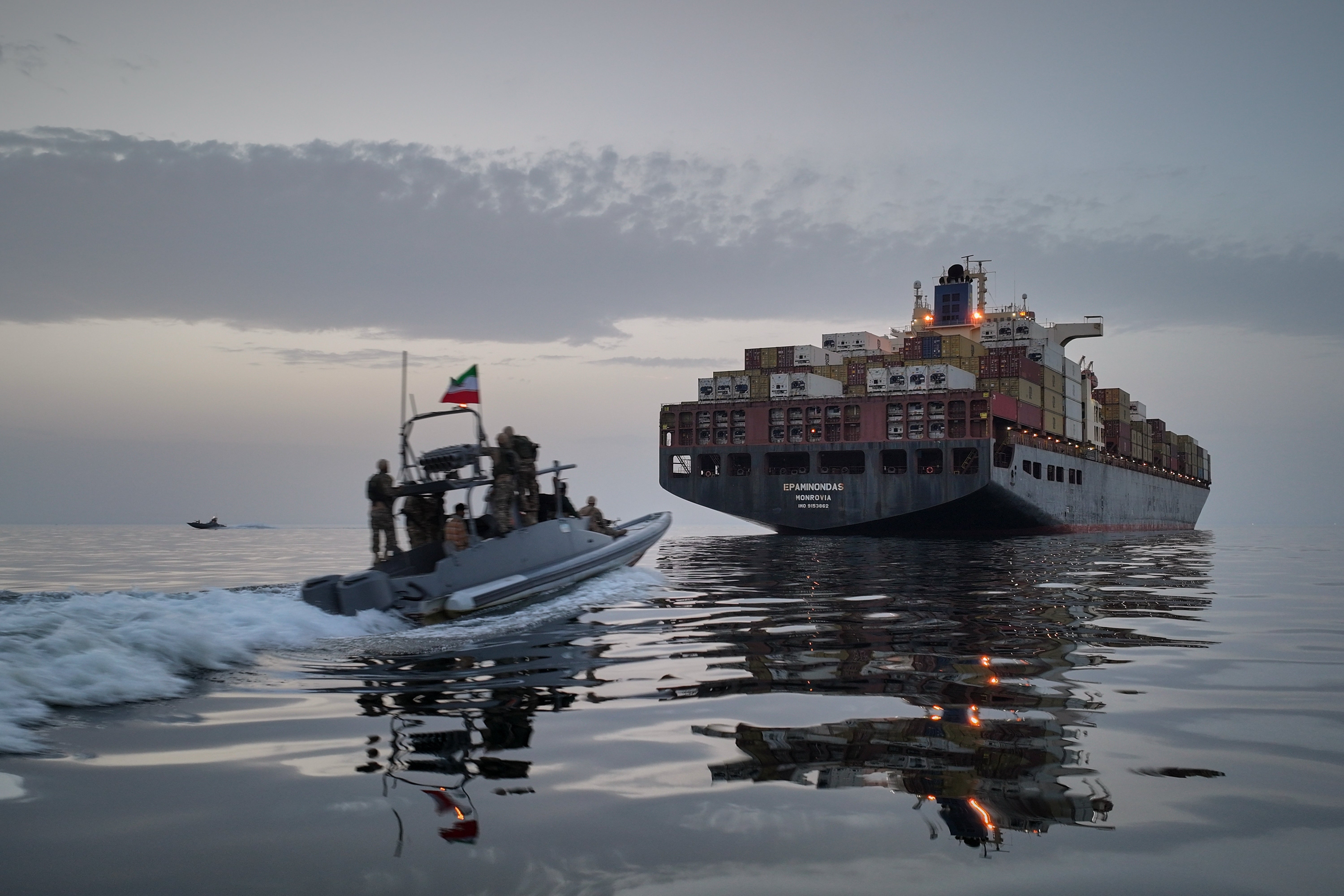 In this photo released by Tasnim News Agency on 24 April, a Revolutionary Guard Navy (IRGC) speedboat approaches the cargo ship Epaminondas during what state media described as the seizure of one of two vessels accused of violations in the Strait of Hormuz,
