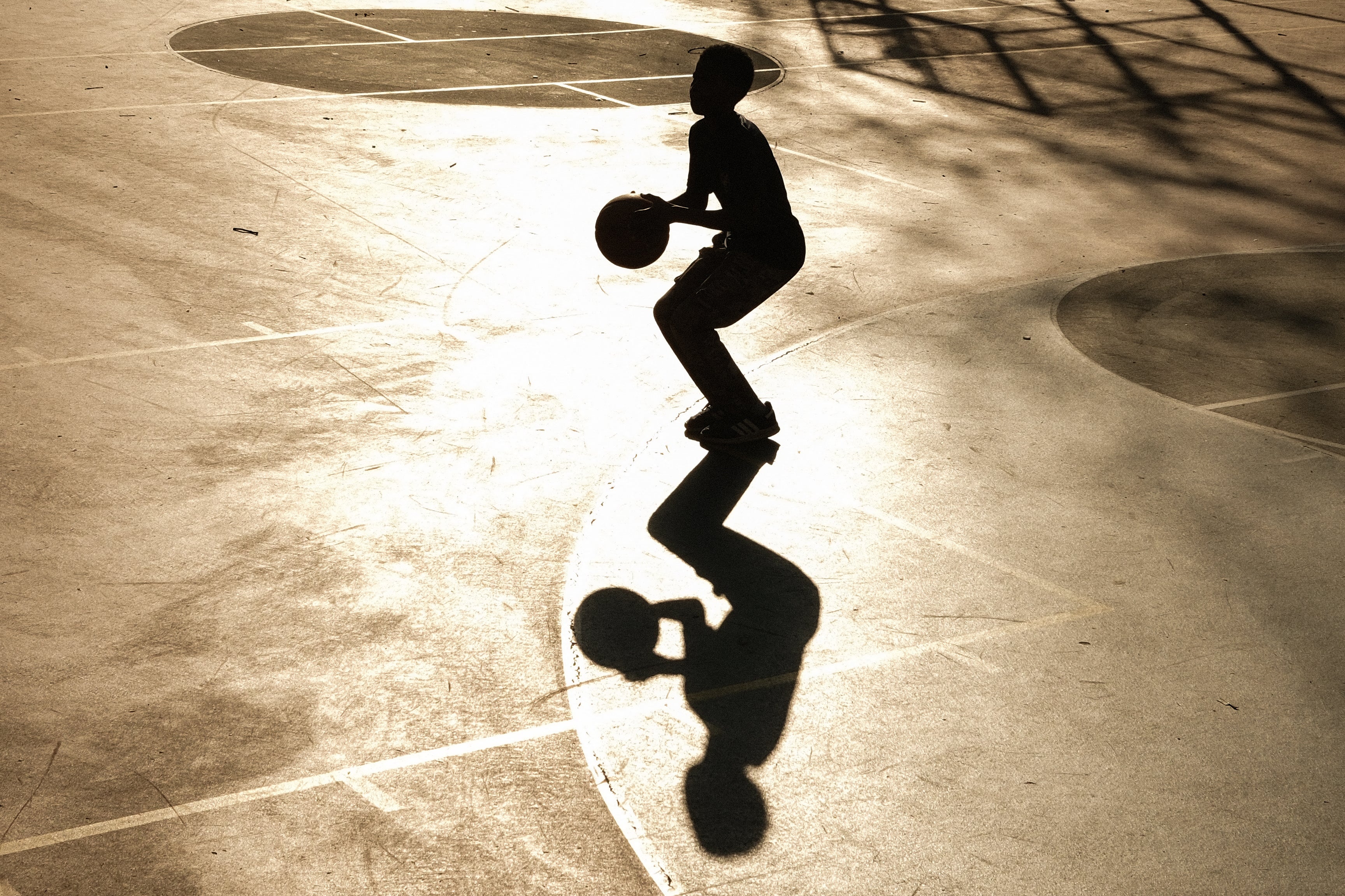 A child plays basketball after school in New York City. More kids have reported feeling lonely or sad in recent years