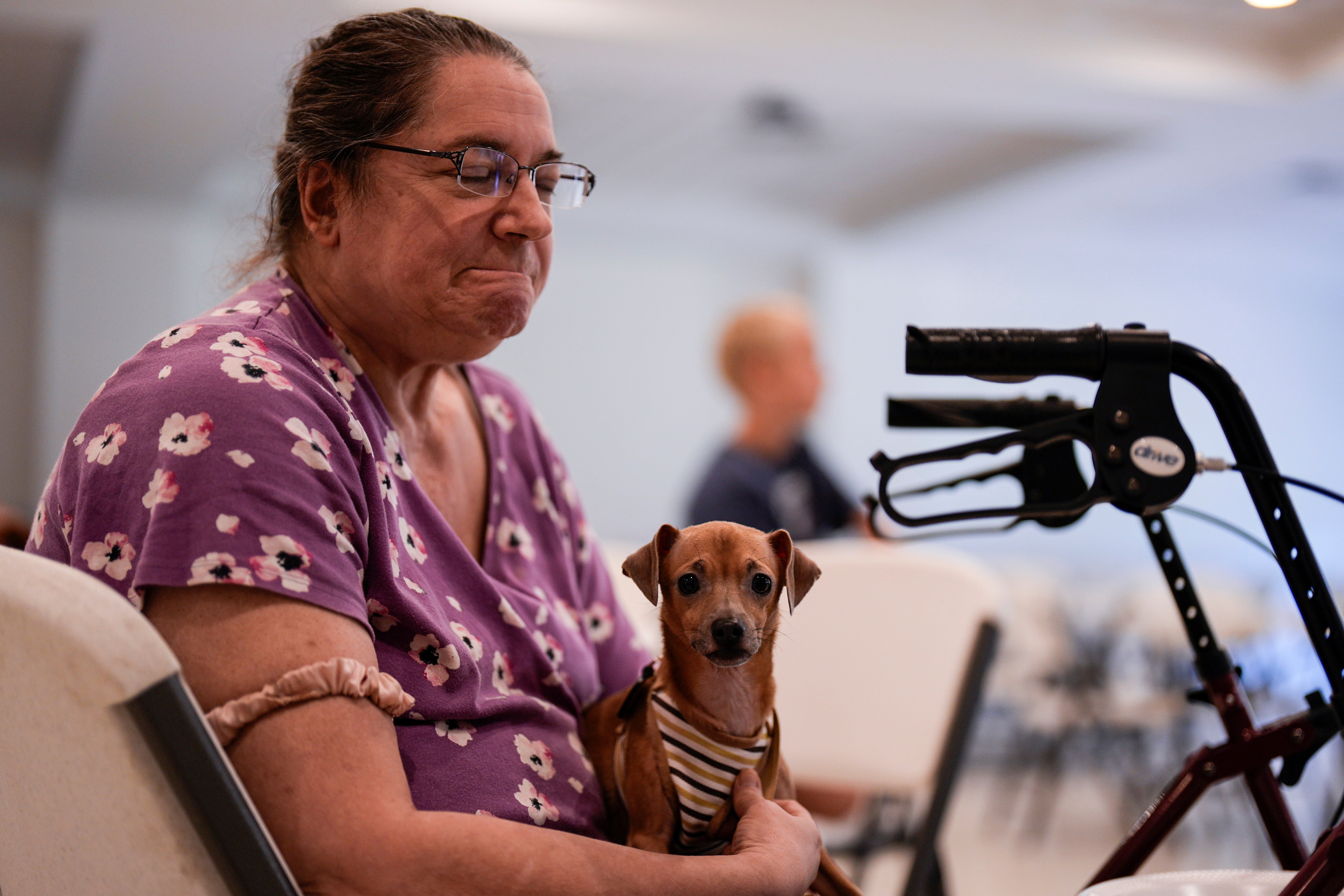 Jennifer Murphy and her dog Chip sit inside the Southside Baptist church