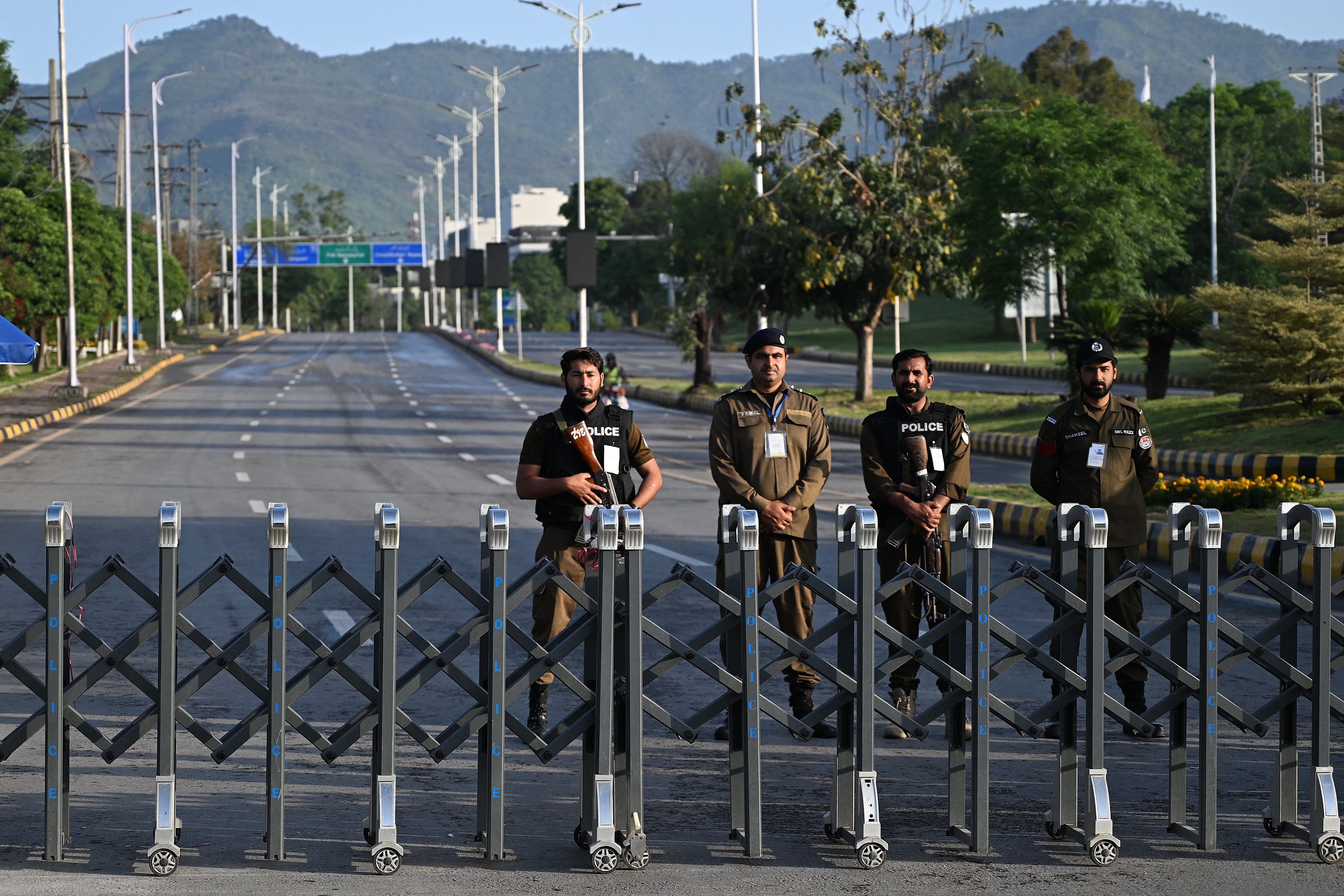 Police officers stand guard near the Serena Hotel, the venue for expected US-Iran talks, in Islamabad's Red Zone