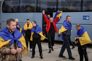 Ukrainian prisoners of war (POWs) react after a swap, amid Russia's attack on Ukraine, at an unknown location in Ukraine
