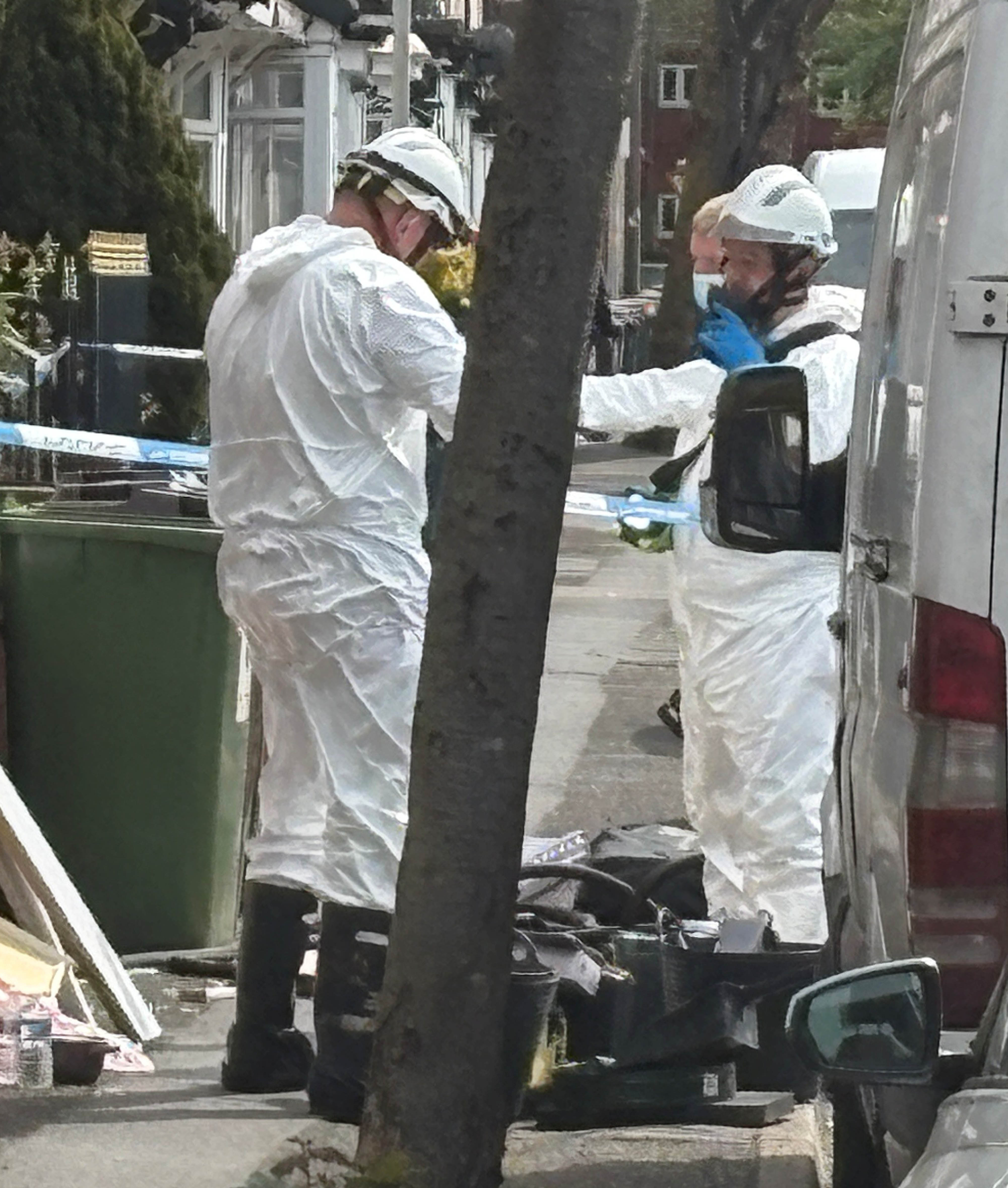 Investigators wearing protective clothing were seen combing the property on Saturday