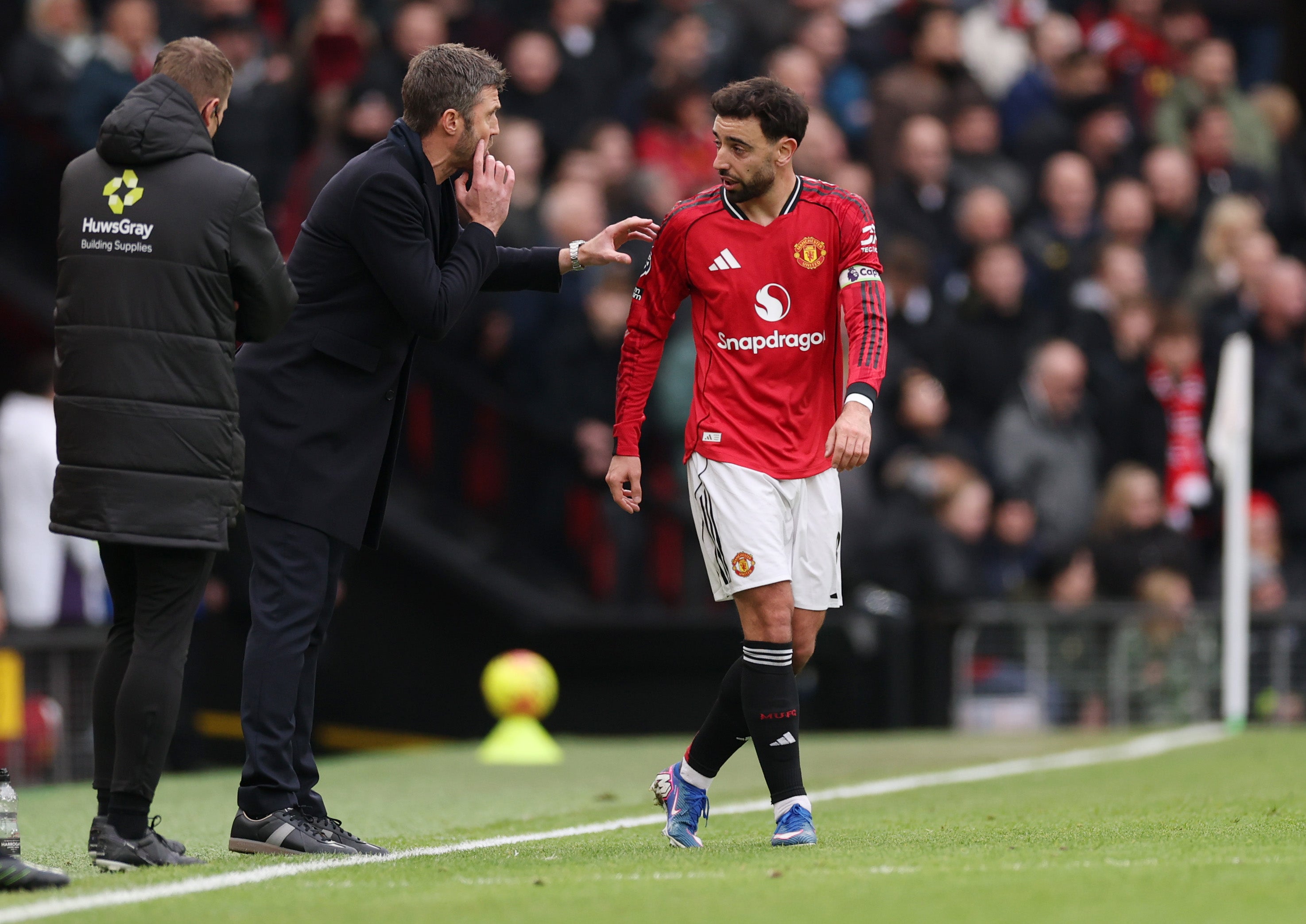 Michael Carrick (left) gives instructions to Manchester United midfielder Bruno Fernandes