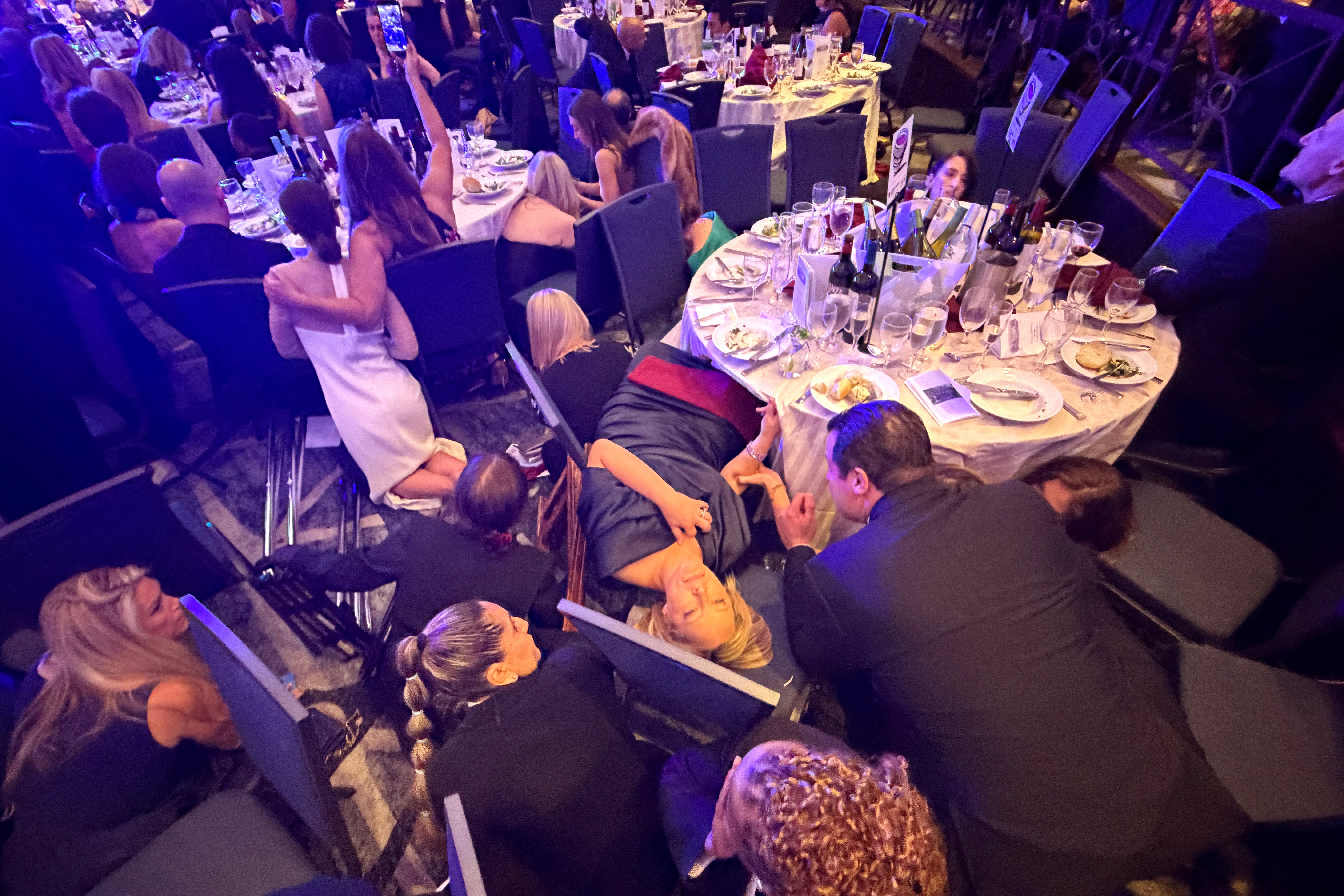 Attendees duck for cover at the White House Correspondents’ Dinner Saturday night