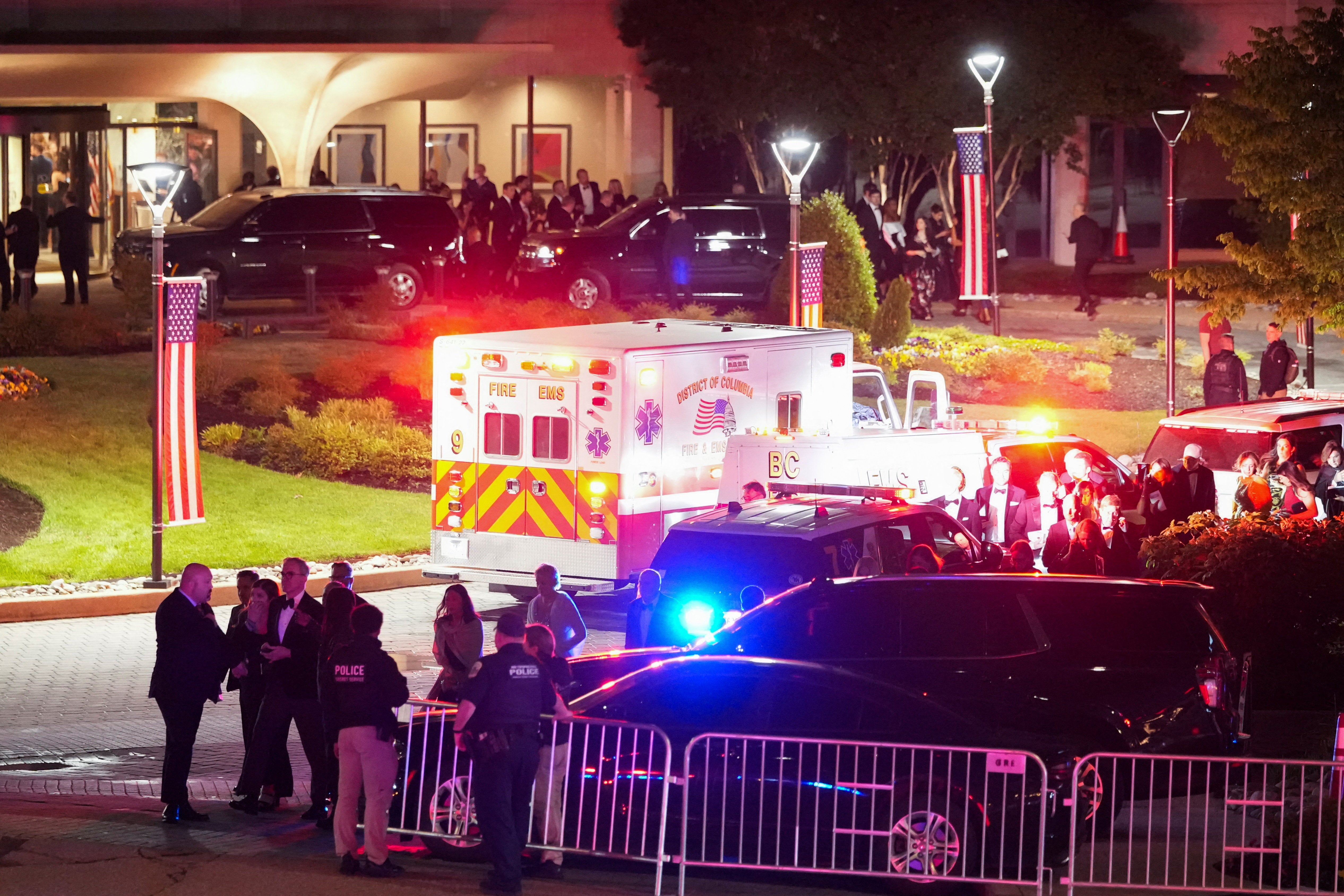 An ambulance awaits White House Correspondents’ dinner attendees after a shooter opened fire at the annual event