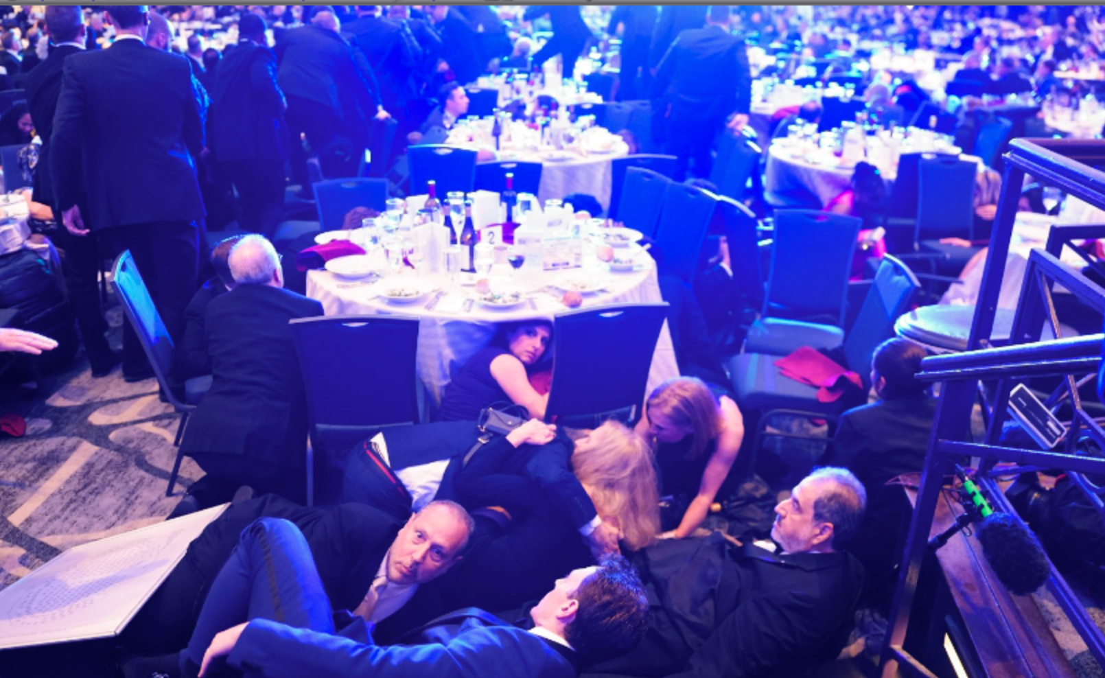 Attendees seen taking cover on the ground