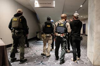 Law enforcement personnel patrol the venue, following a shooting incident during the annual White House Correspondents' Association dinner, in Washington, DC, US, 26 April 2026