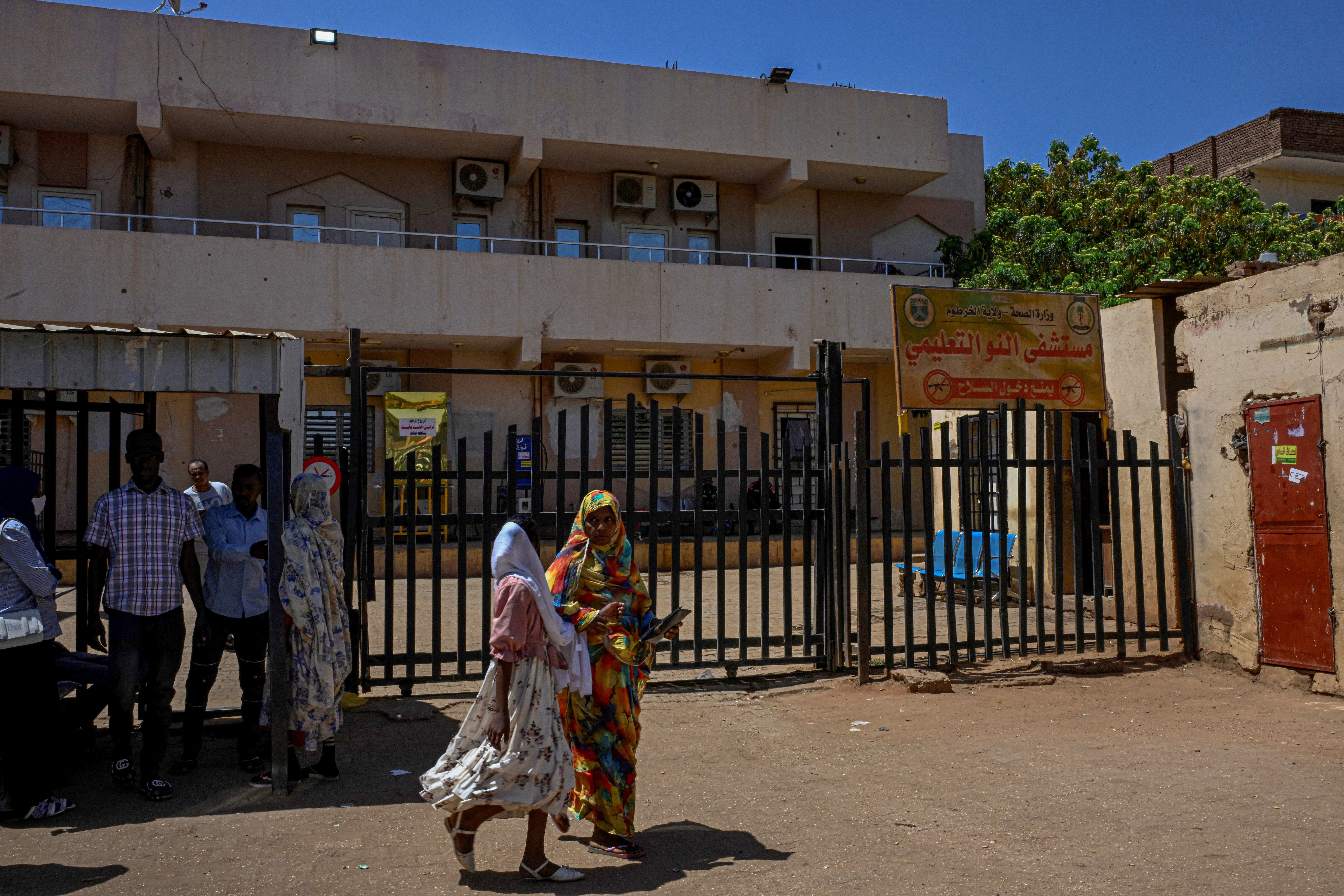 People standing outside the Al-Nao Educational Hospital