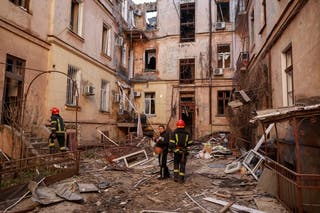 Rescuers work at a site of apartment buildings hit by a Russian drone strike in Odesa, on Monday