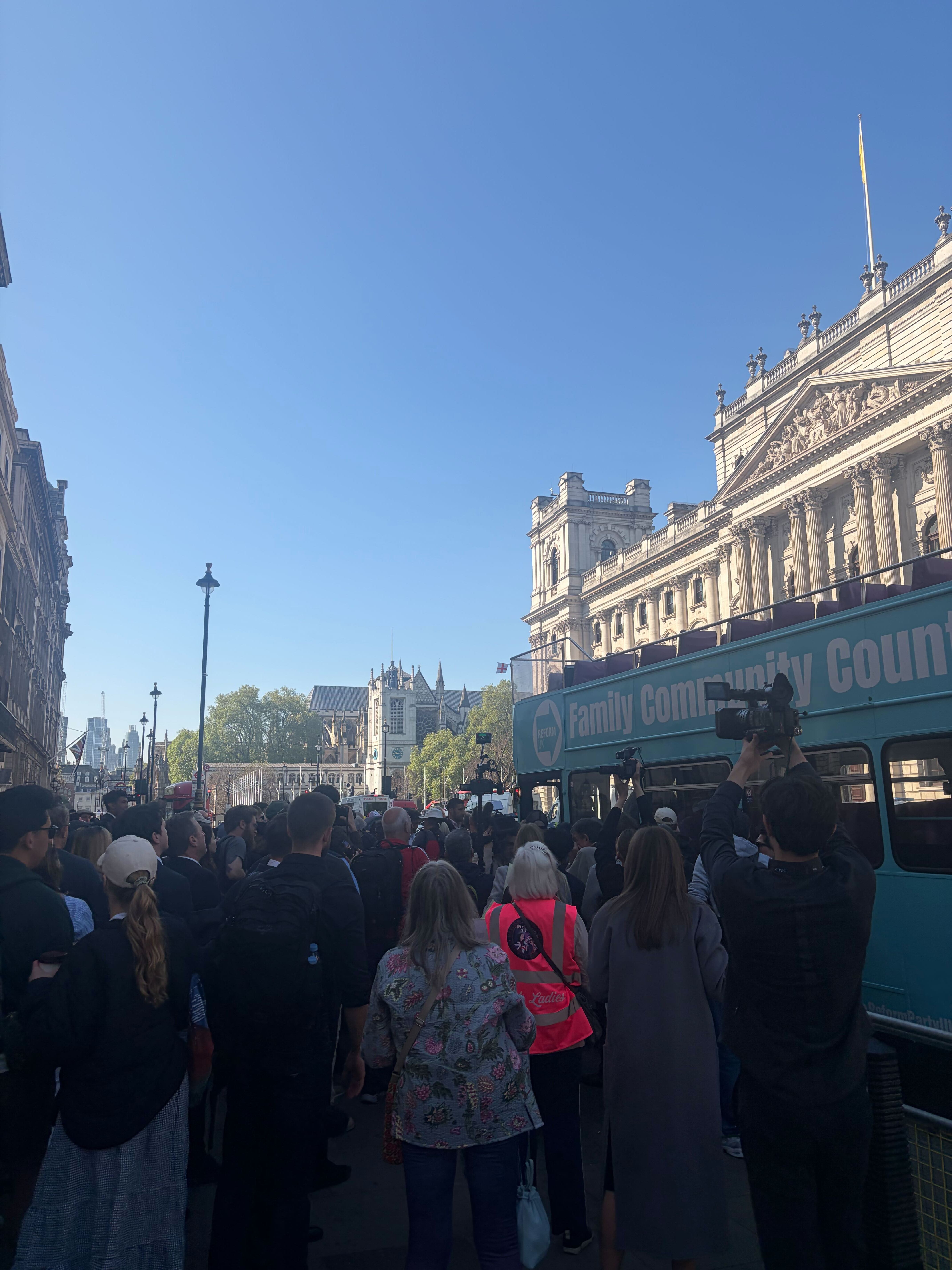 Only a few dozen spectators gathered on the street by the bus, the majority from the media