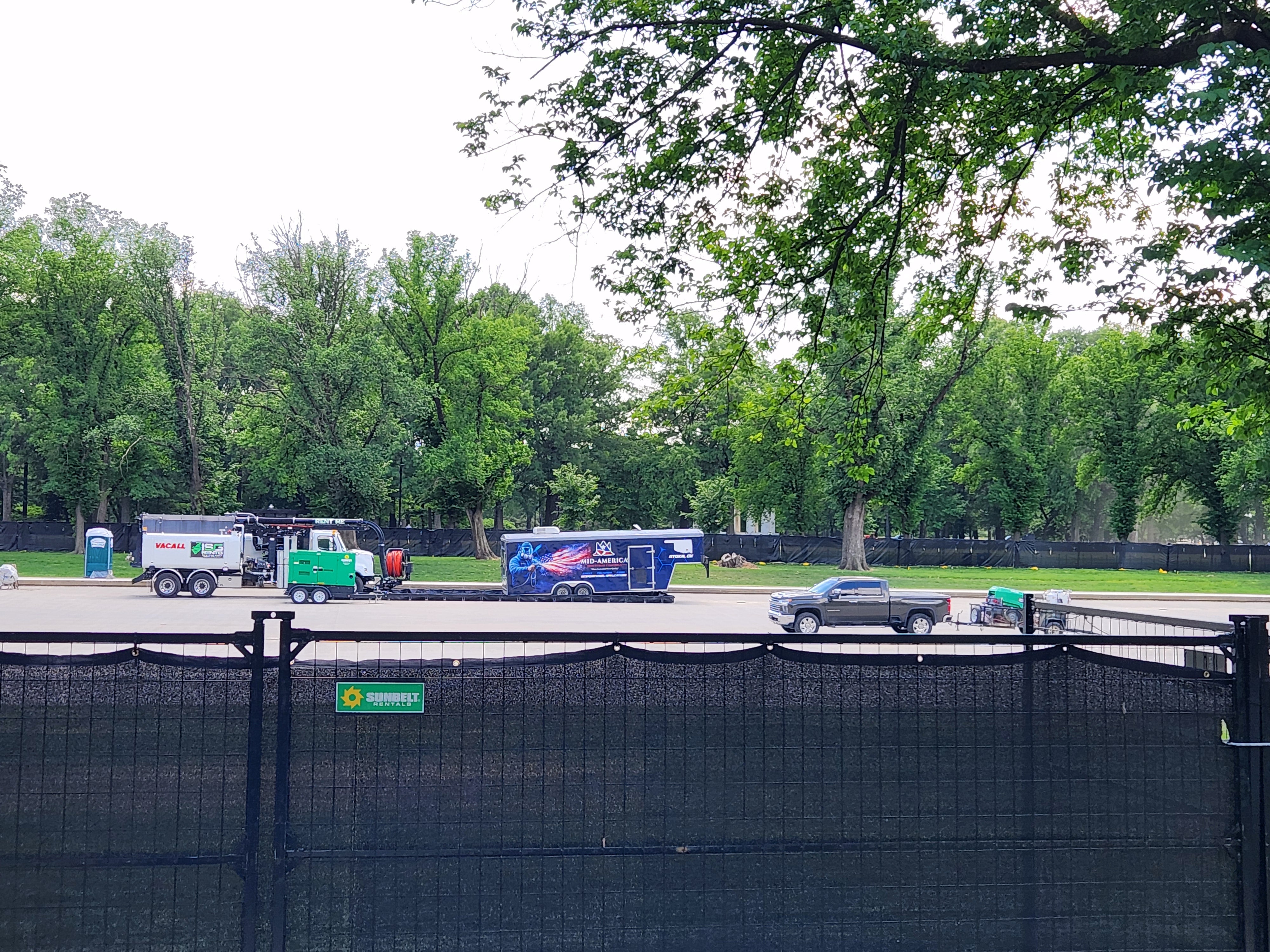 Port-a-potties visible to tourists at the drained Reflecting Pool as work begins on the project amid peak D.C. tourism season