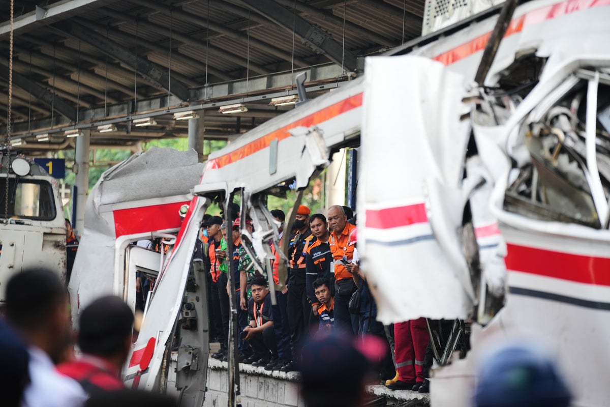 Rescuers trying to reach 3 people trapped in damaged train car after crash in Indonesia