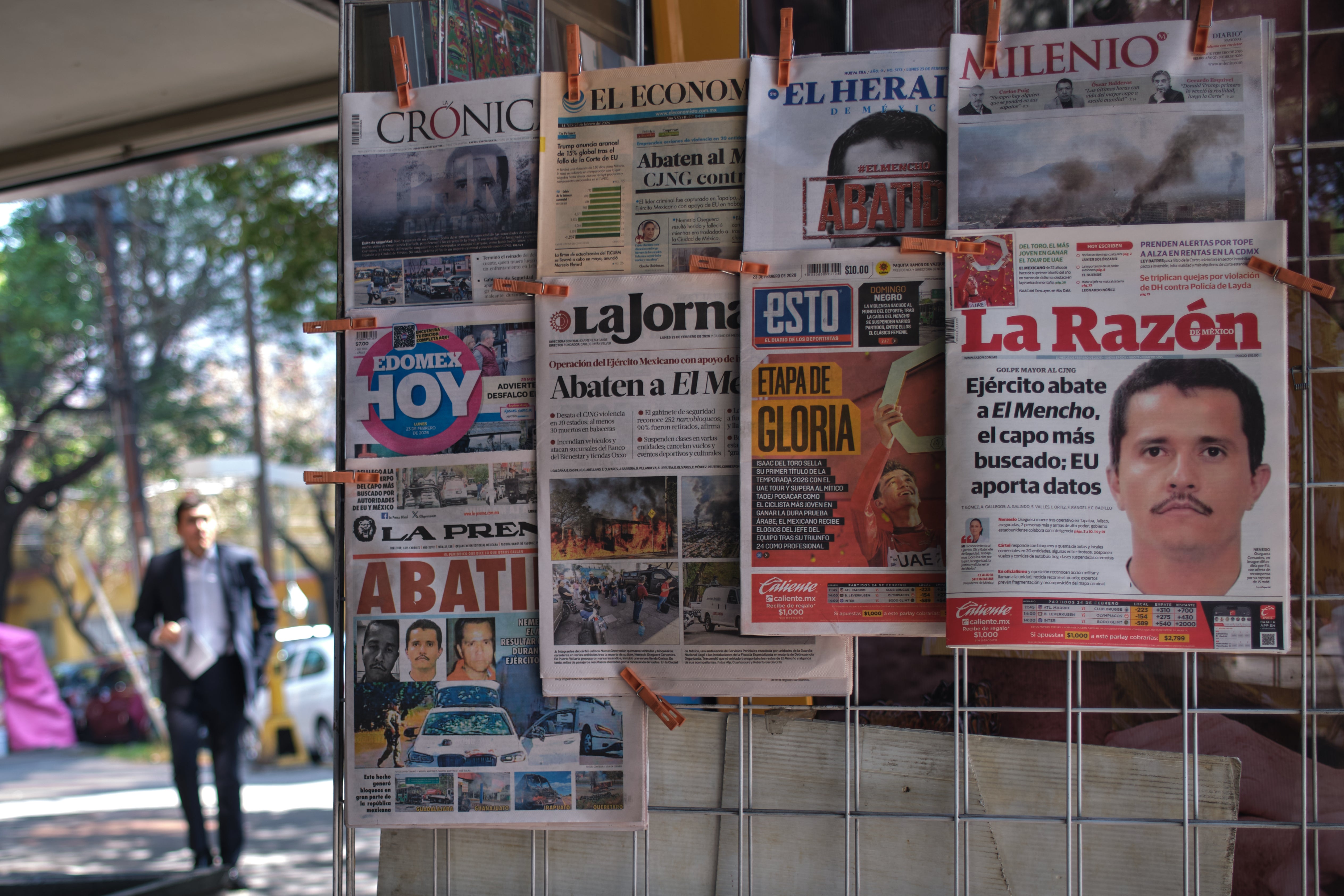 Newspapers hang on display for sale in Mexico City, Monday, Feb. 23, 2026, a day after the Mexican army killed Jalisco New Generation Cartel leader Nemesio Oseguera Cervantes, known as “El Mencho”