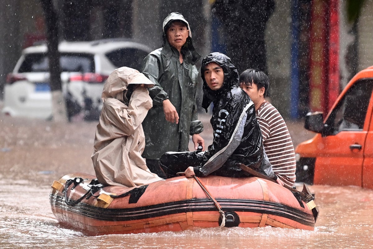 Heavy flooding in southern China forces evacuations and leaves vehicles submerged