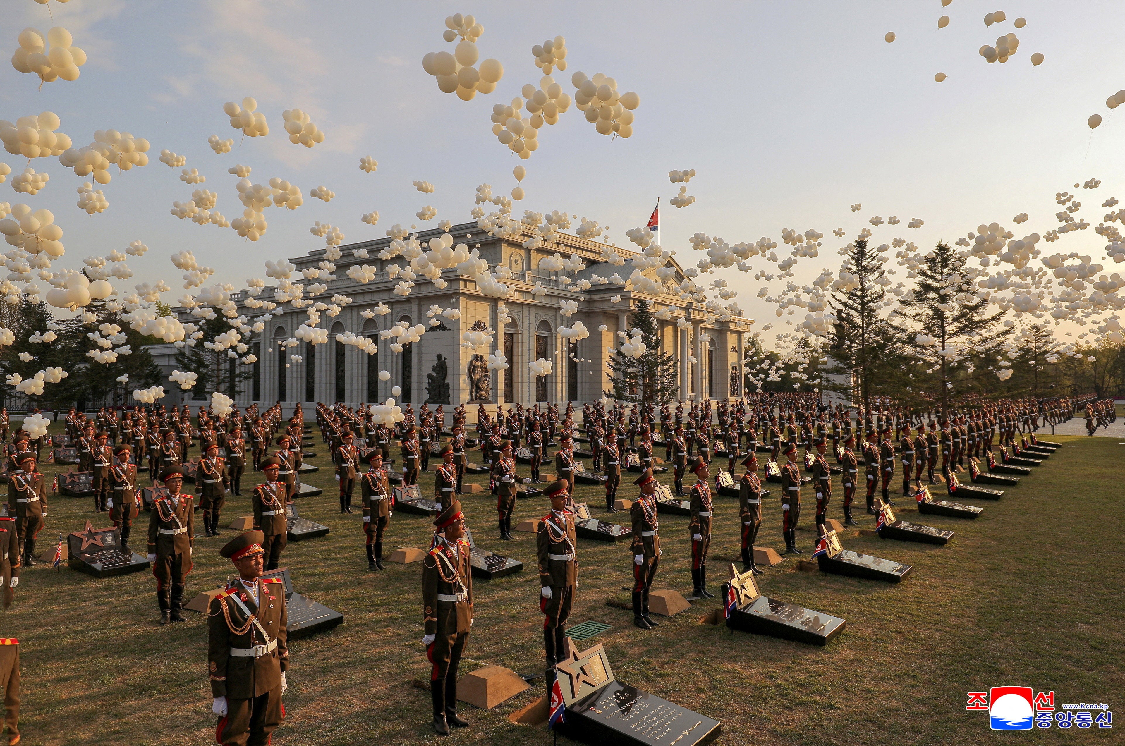 Balloons fly as soldiers stand in position next to memorial stones during the opening ceremony of the Memorial Museum of Combat Feats at the Overseas Military Operations honouring North Korean troops killed while fighting for Russia in the war against Ukraine, in Pyongyang