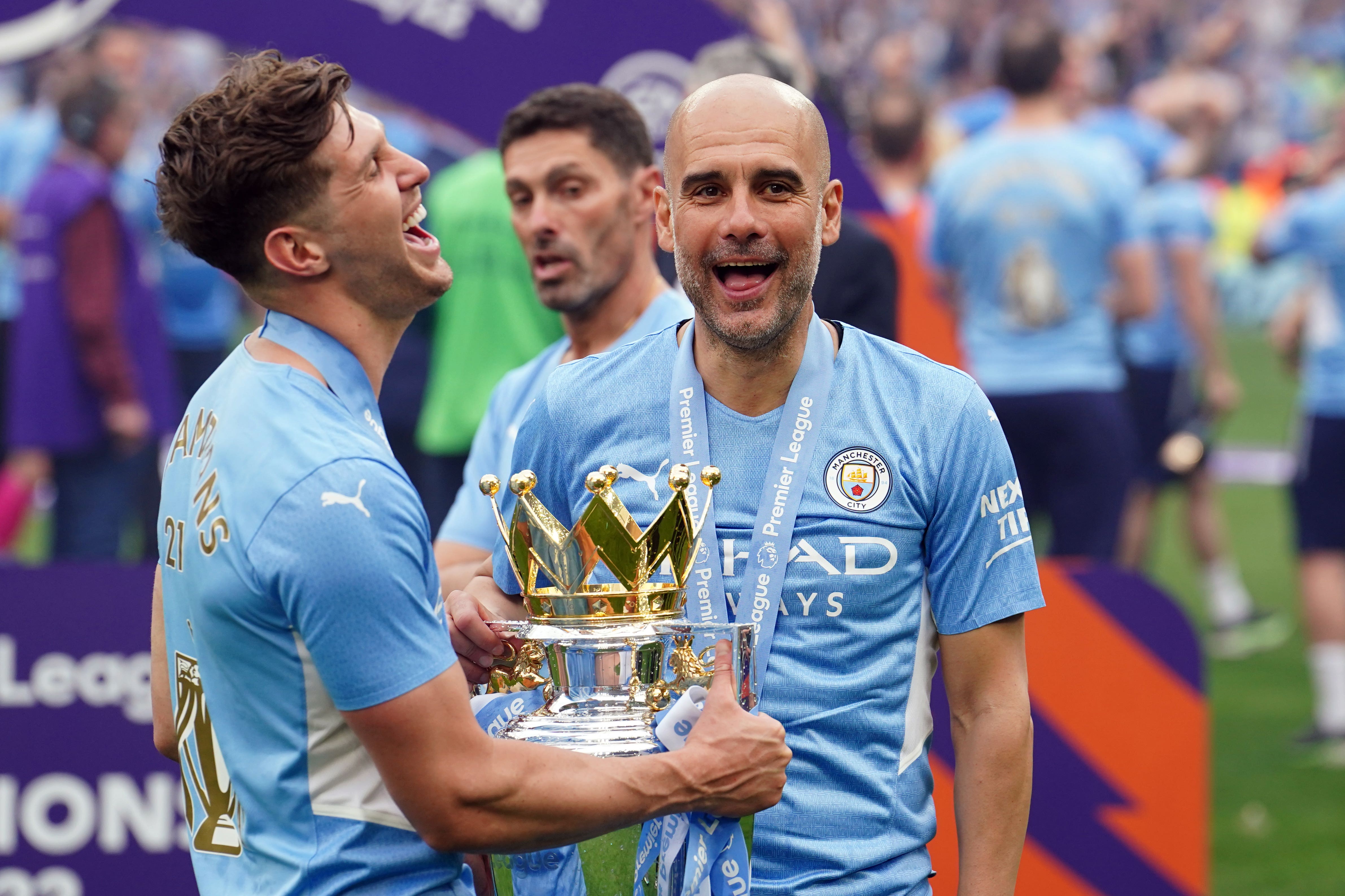 John Stones, left, and Pep Guardiola with the Premier League trophy