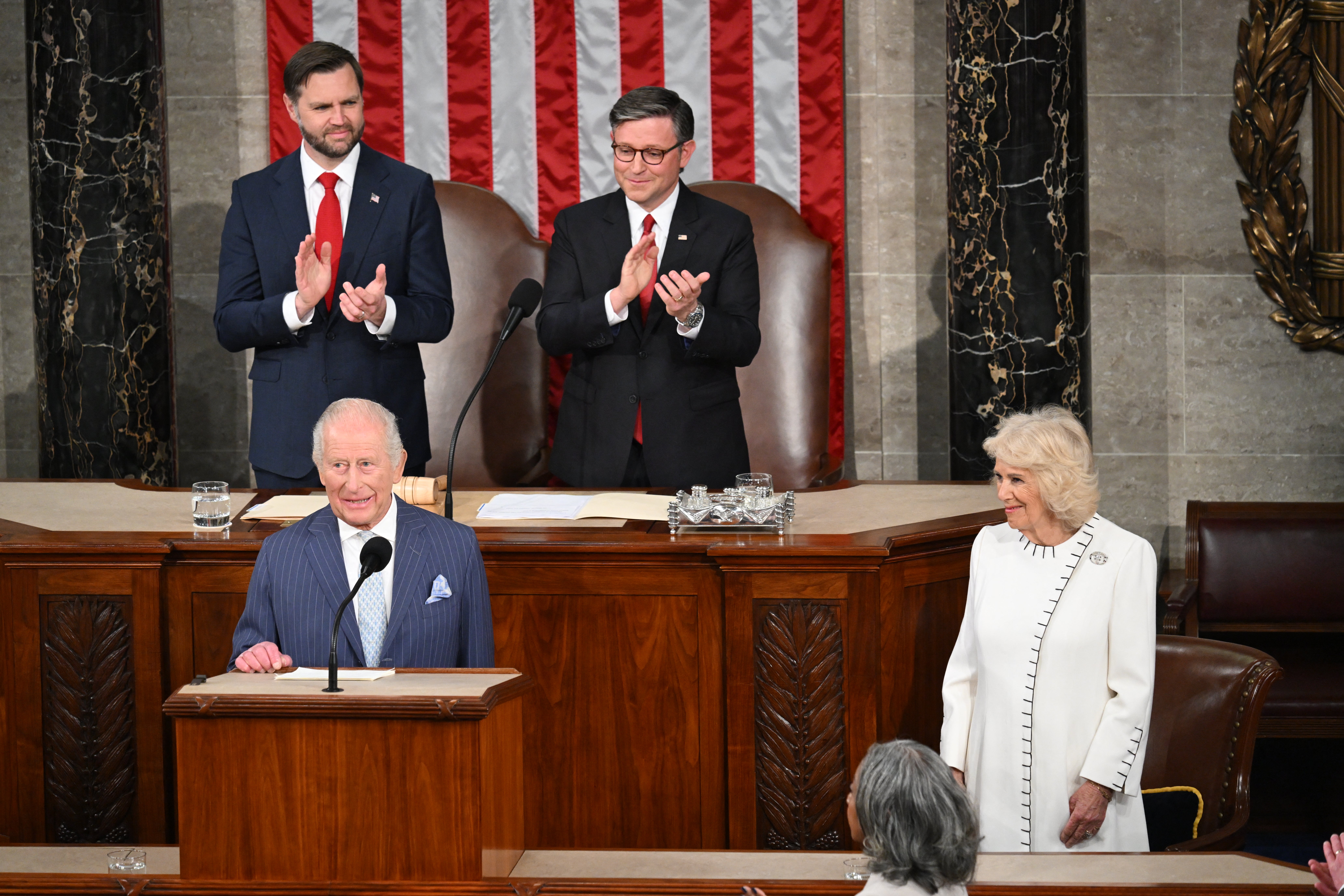 House Speaker Mike Johnson, US Vice President JD Vance and Queen Camilla applaud the King