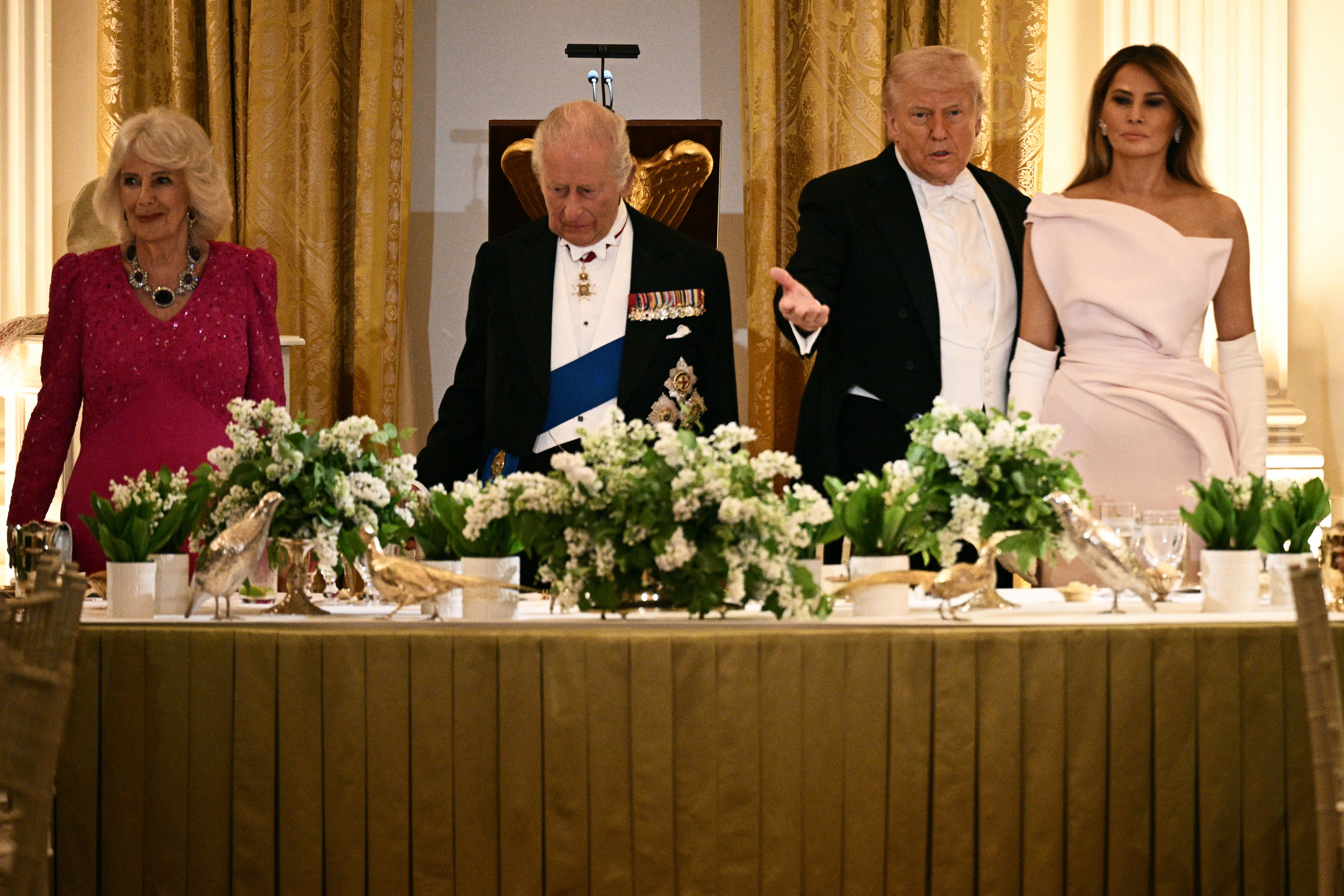U.S. President Donald Trump and first lady Melania Trump welcome Britain's King Charles and Queen Camilla as they arrive for a state dinner at the White House in Washington, D.C.