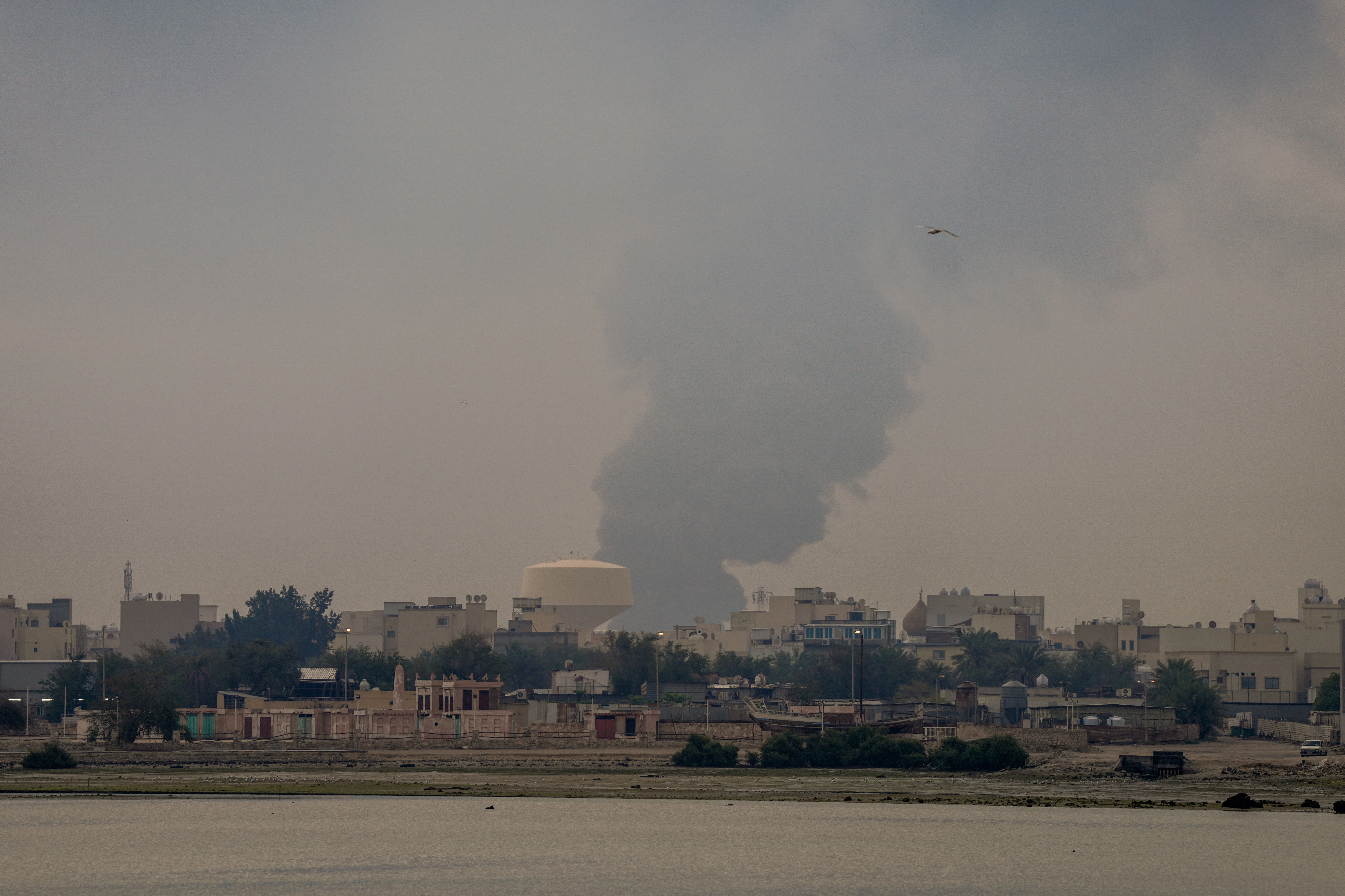 A plume of smoke rises after a reported Iranian strike on fuel tanks in Muharraq in Bahrain on 12 March 2026