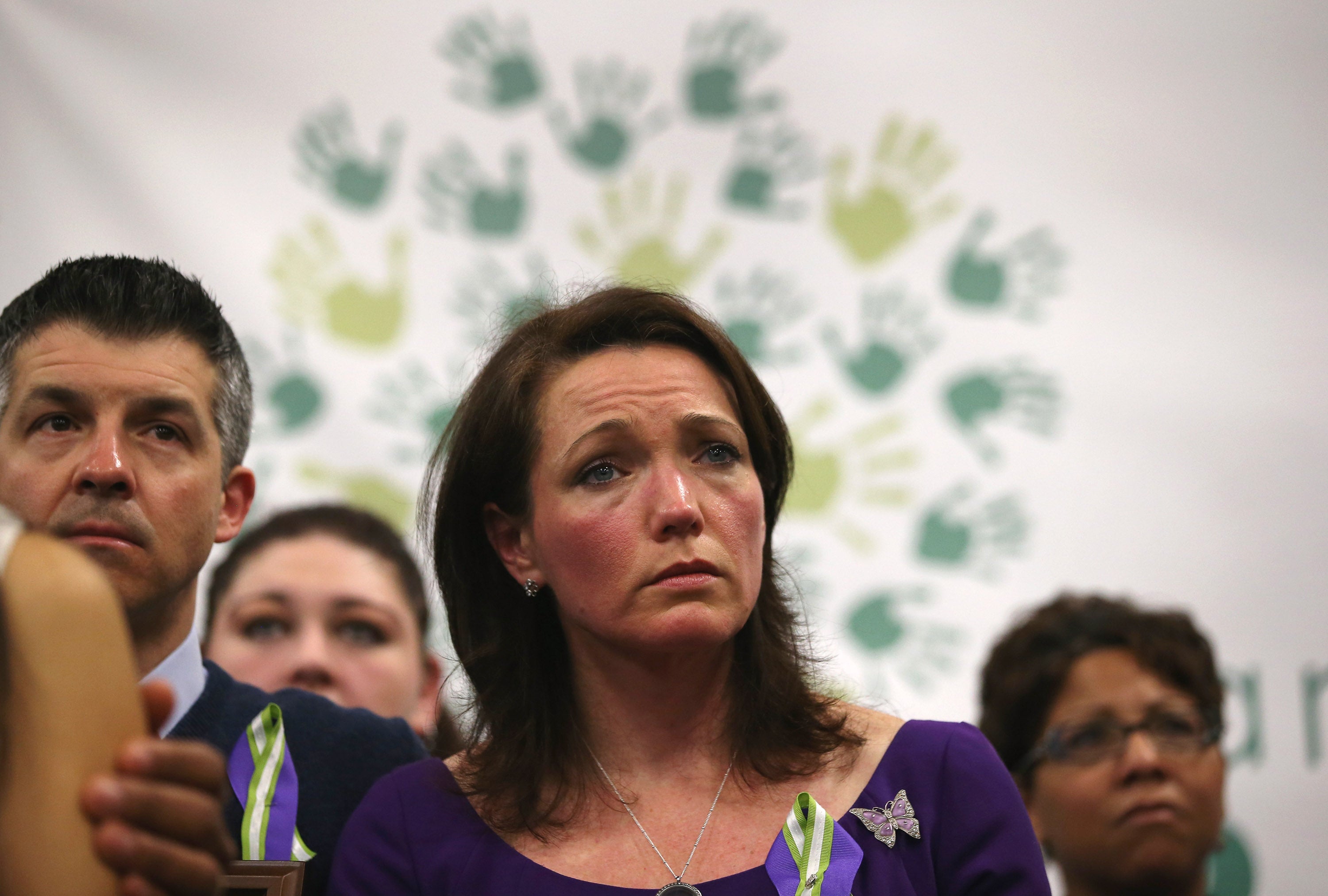 Nicole and Ian Hockley, parents of Sandy Hook massacre victim Dylan Hockley, listen during a press conference with fellow parents of victims on the one month anniversary of the Newtown elementary school massacre on January 14, 2013 in Newtown, Connecticut