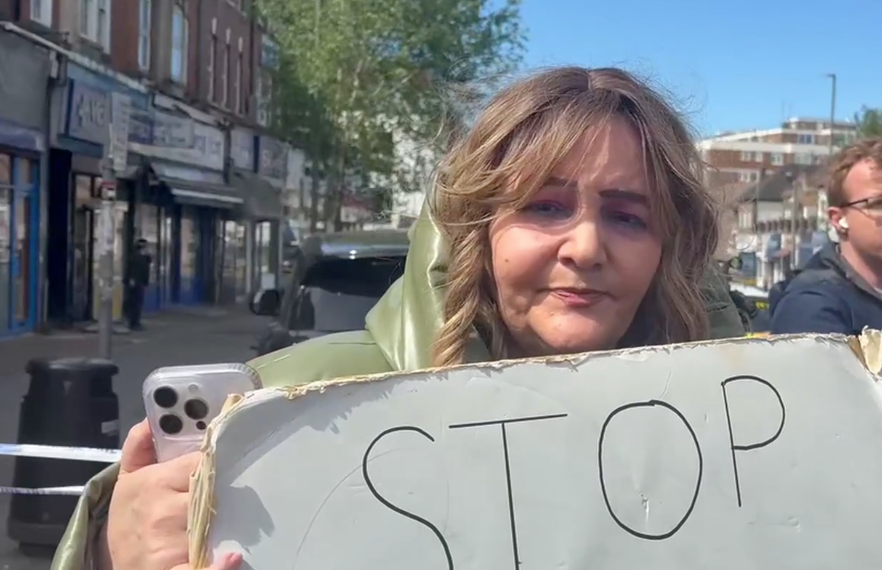 Ambrosine Shitrit with a sign reading 'stop the attack on Jews'