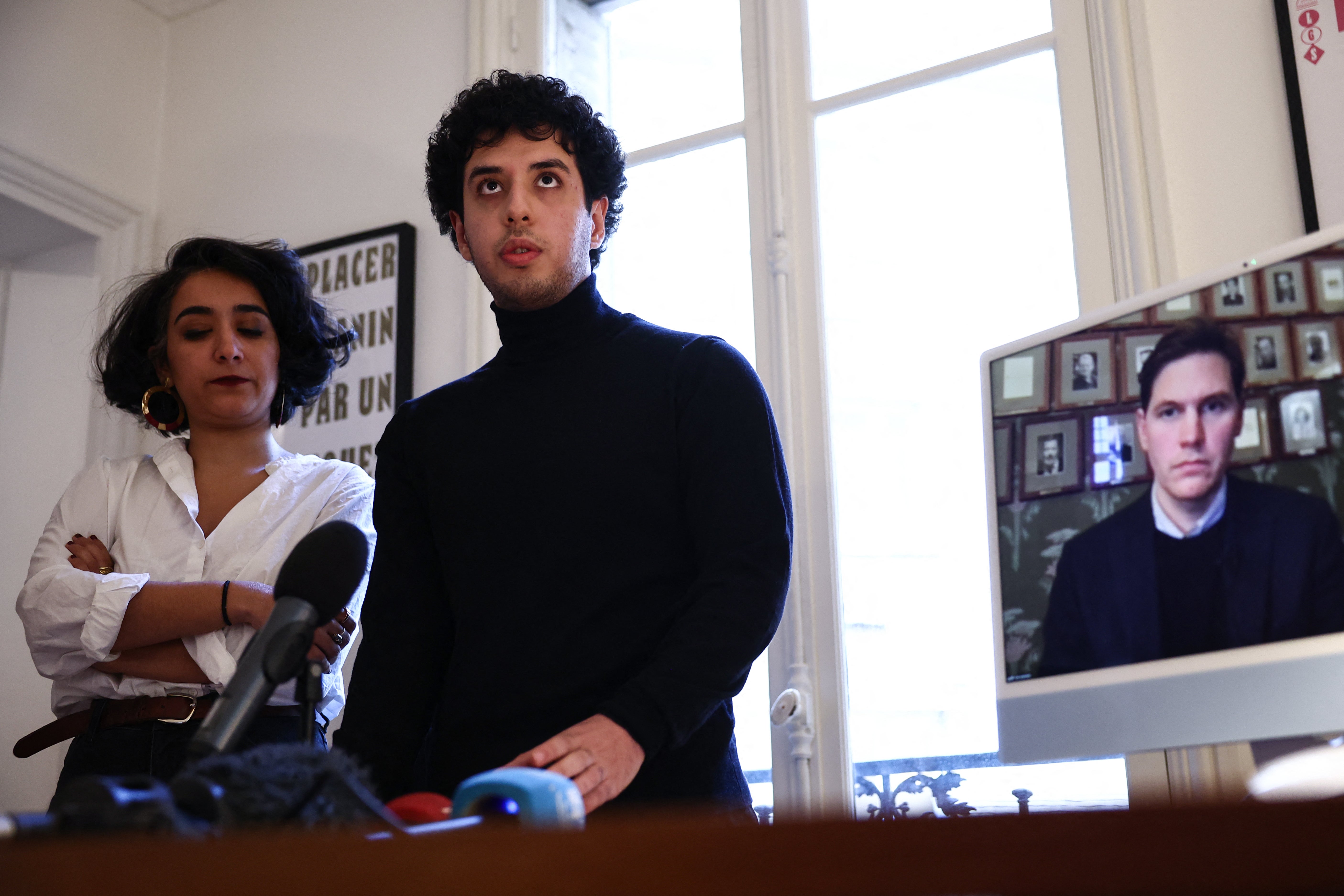The family lawyer Chirinne Ardakani (L), Ali Rahmani, son of Narges Mohammadi, and head of the Norwegian Nobel Committee, Jorgen Watne Frydnes (on screen) hold a press conference after Iranian Nobel Peace Prize winner Narges Mohammadi, who has been incarcerated in Tehran since November 2021, was temporarily released from prison on medical grounds, in Paris, on December 4, 2024