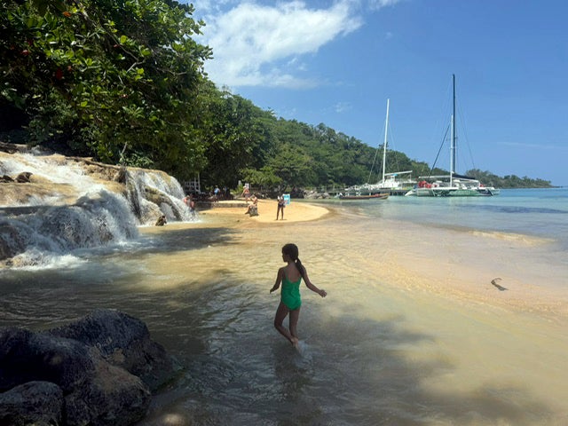 Splashing around on the north coast of Jamaica, where Dunn’s River falls flows into the sea
