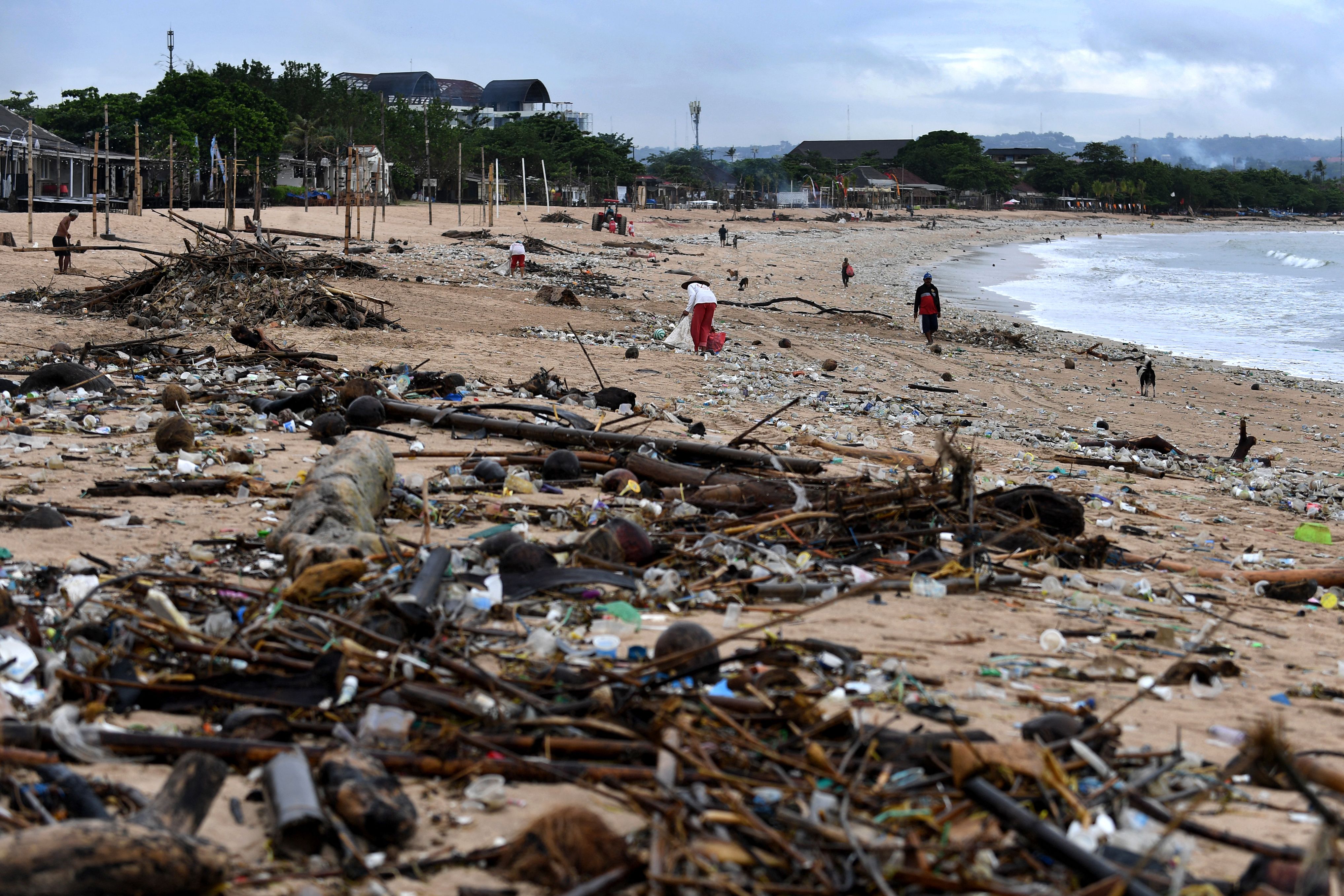 Collectors remove trash from the Kedonganan beach in Bali