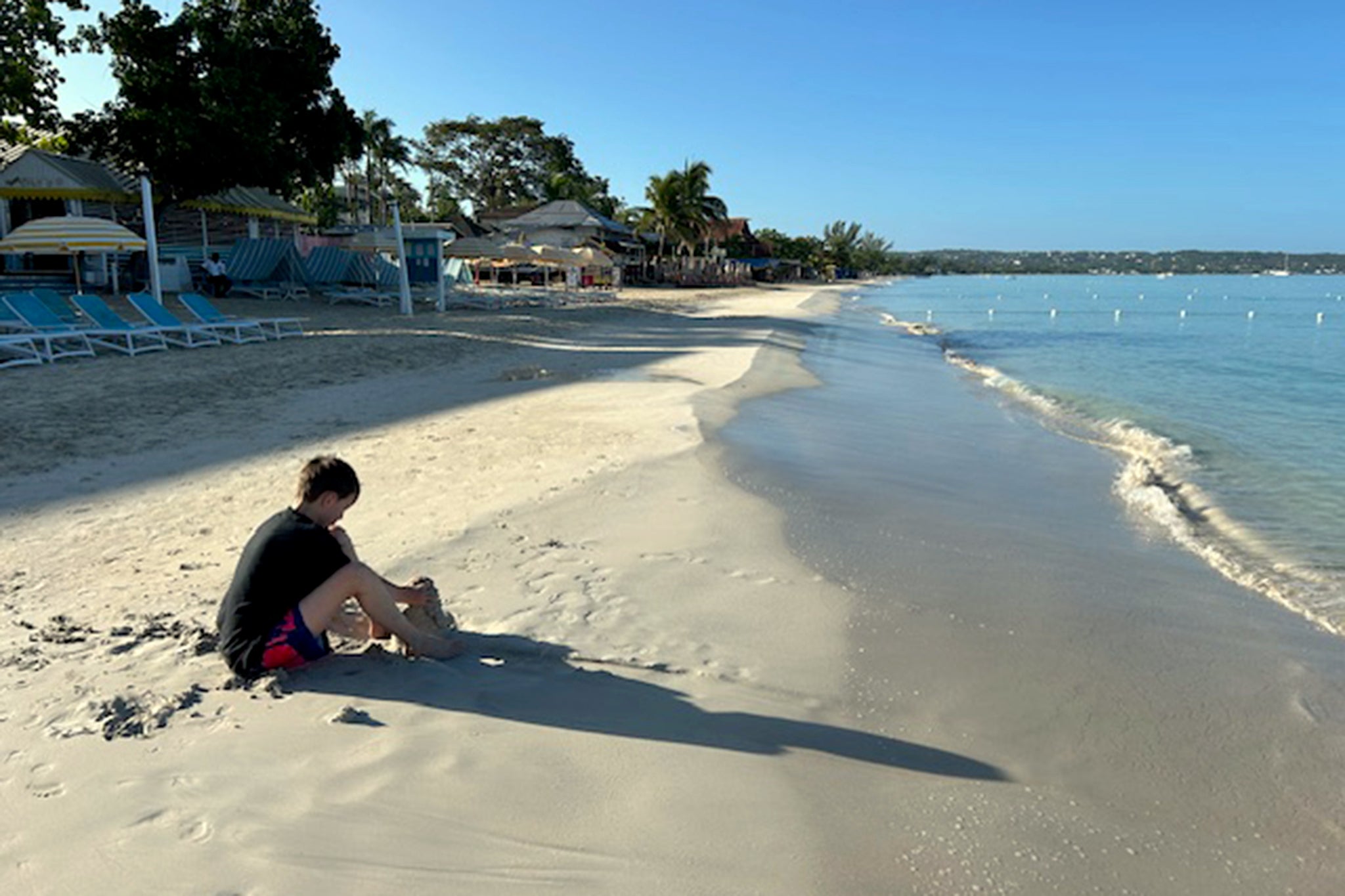 Playing in the sand on Negril beach in the early morning