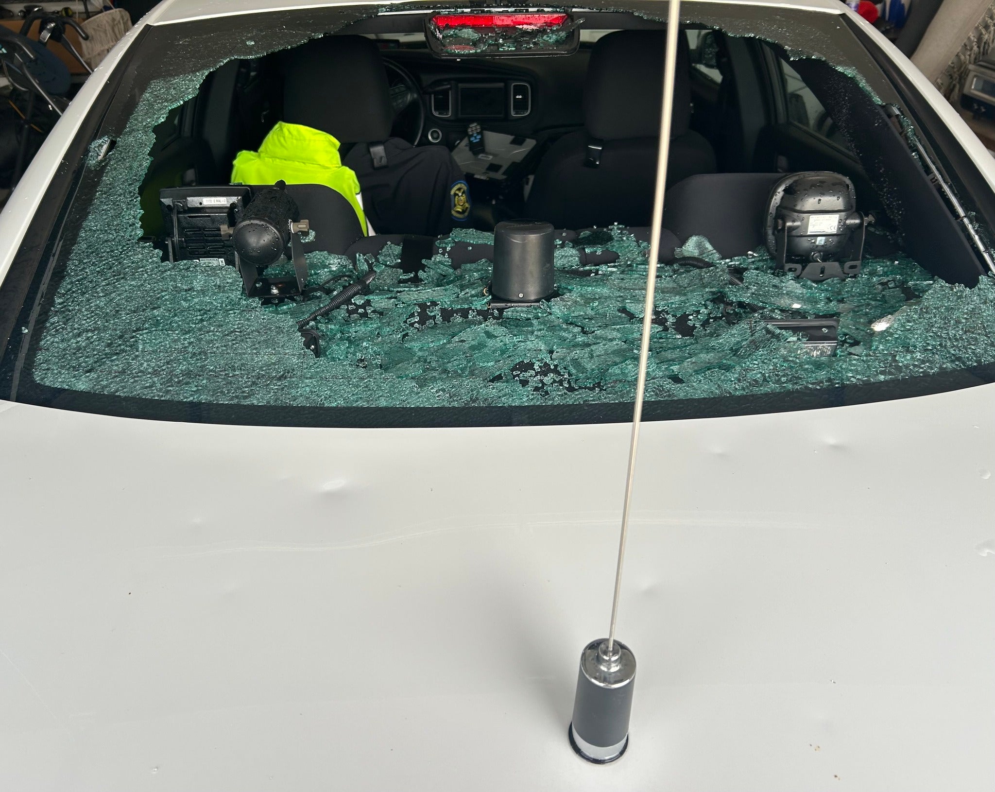 A Missouri State Highway Patrol vehicle's back window is shattered following the storm