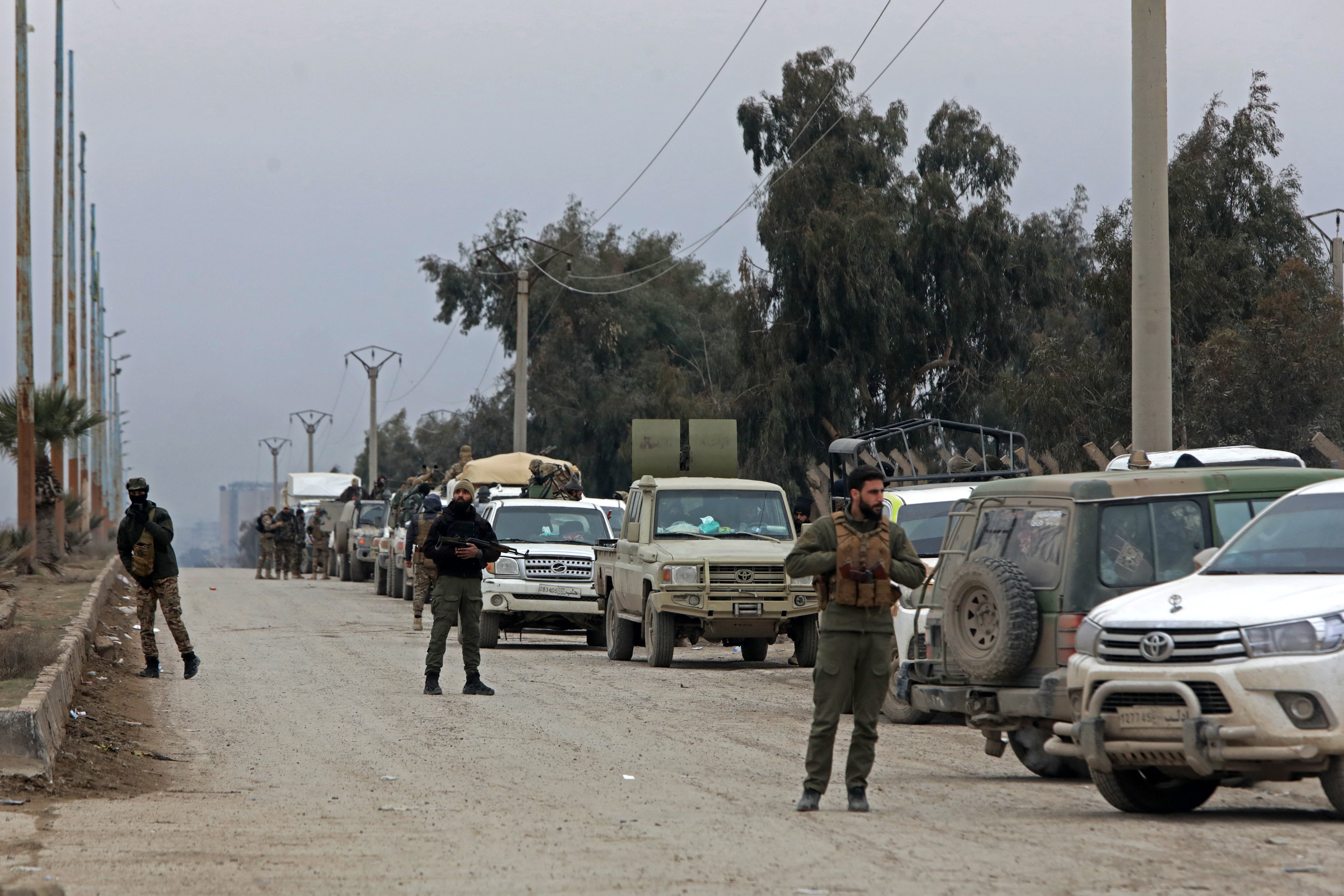 Members of Syrian government security forces stand guard along an area near to Al-Aqtan prison on the outskirts of the northeastern Syrian city of Raqa on January 2026. It is thought Jack has been transferred from Syria to Iraq