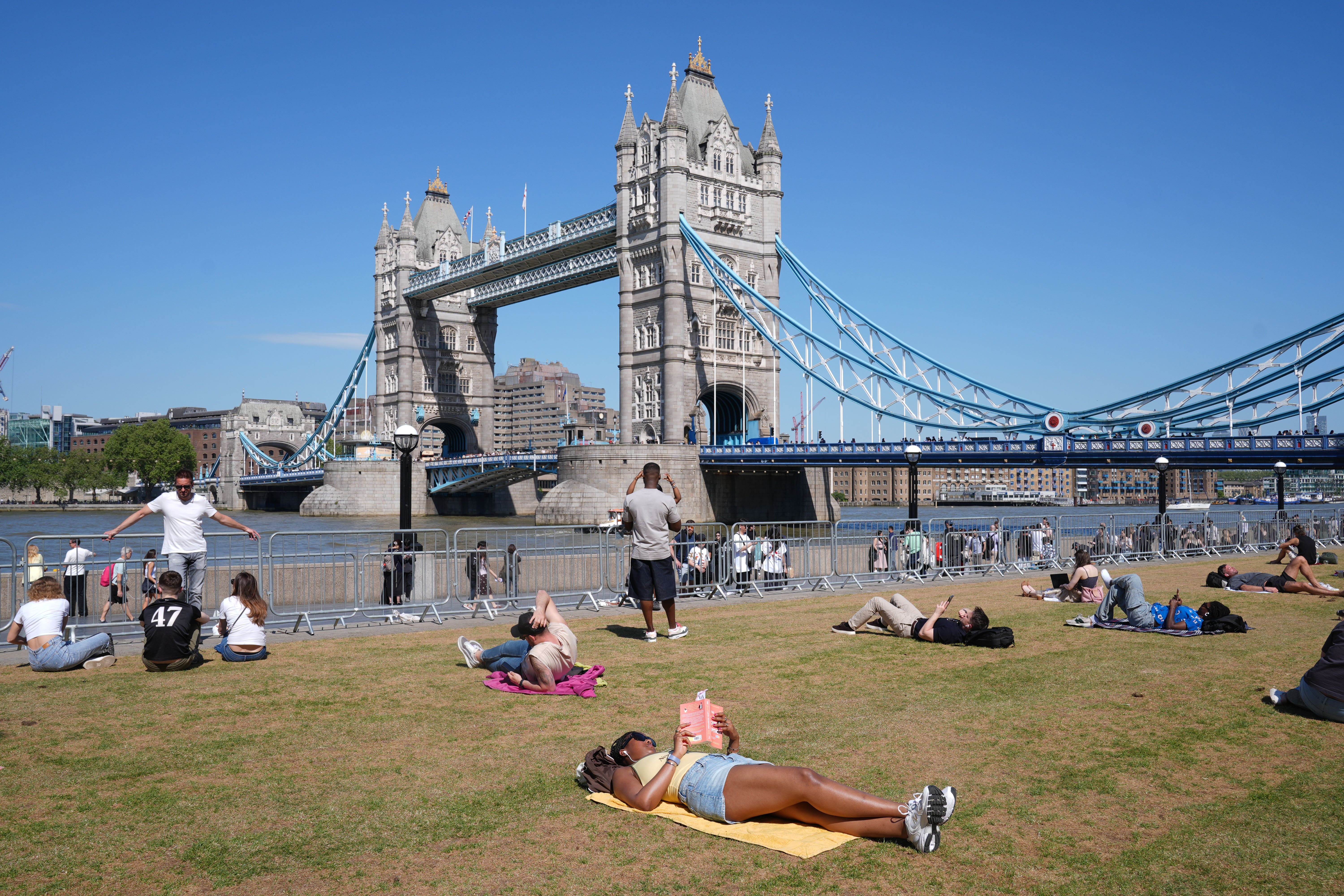 People relaxing in warm weather at Potters Fields Park in London (Lucy North/PA)
