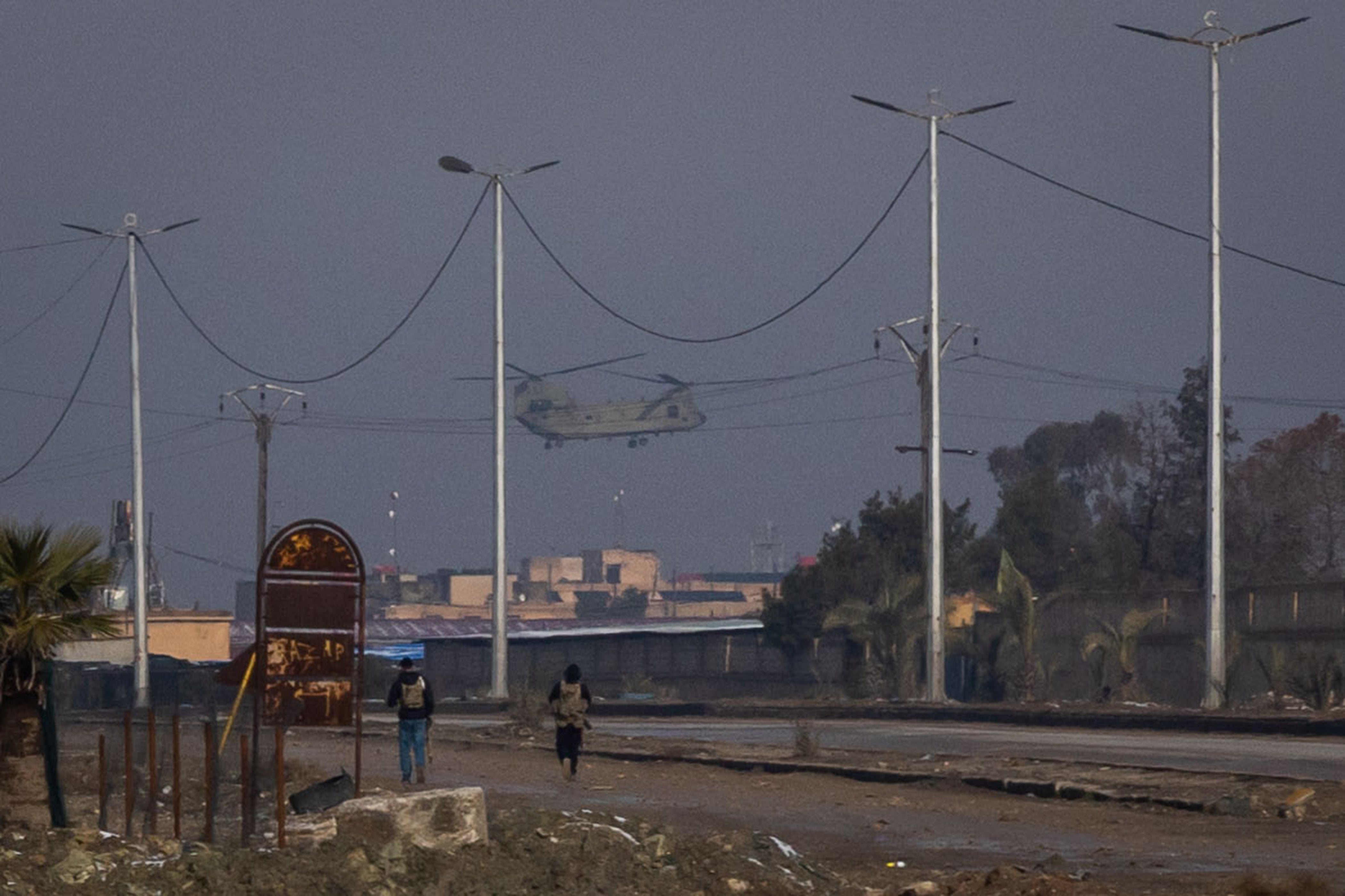 A United States chinook helicopter lands at a prison housing ISIS members January 2026 in Al Hasakah, Syria. Nearly 6,000 people were transferred to Iraq the following month