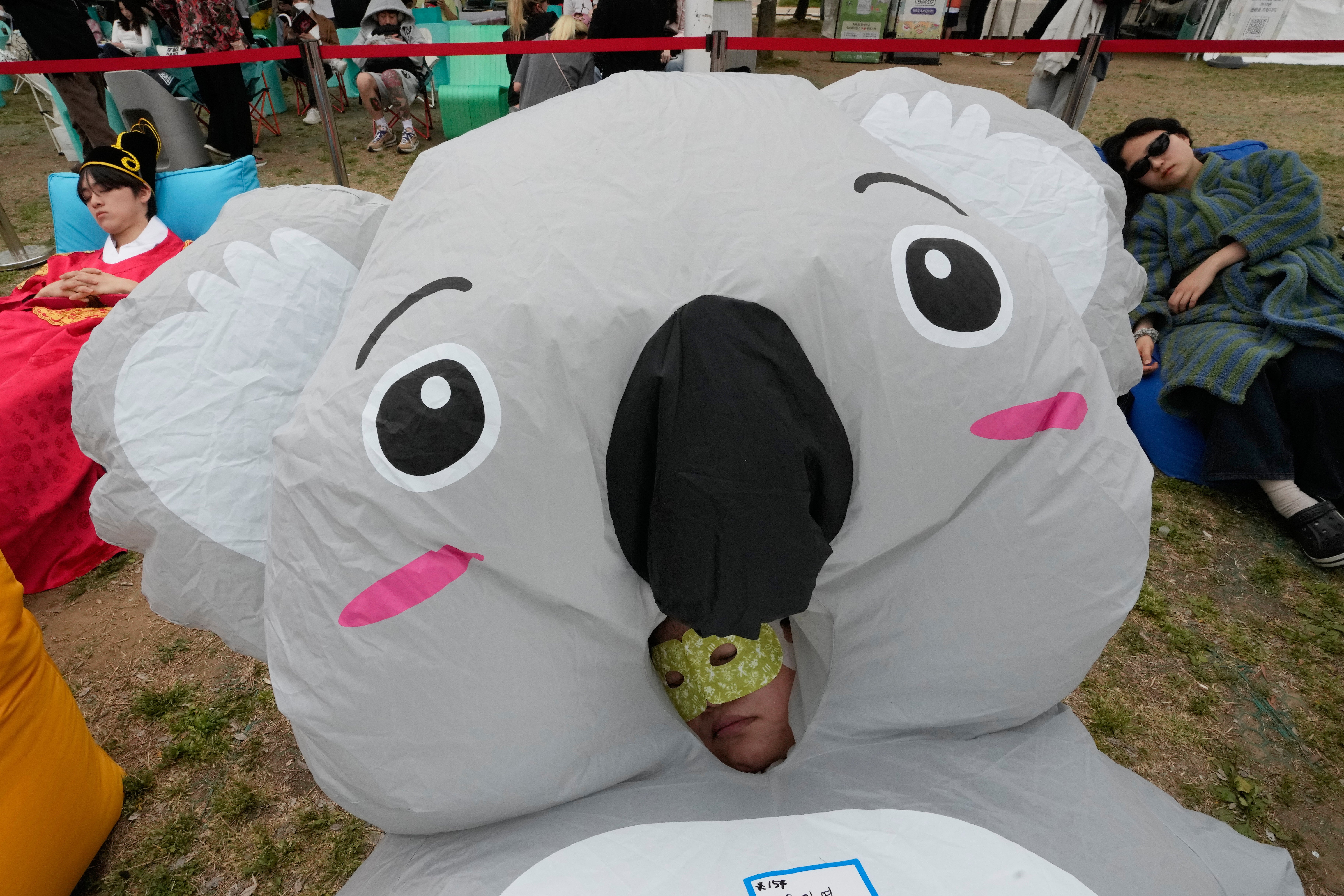 Participants take a nap during the 2026 Hangang Nap Competition in Seoul