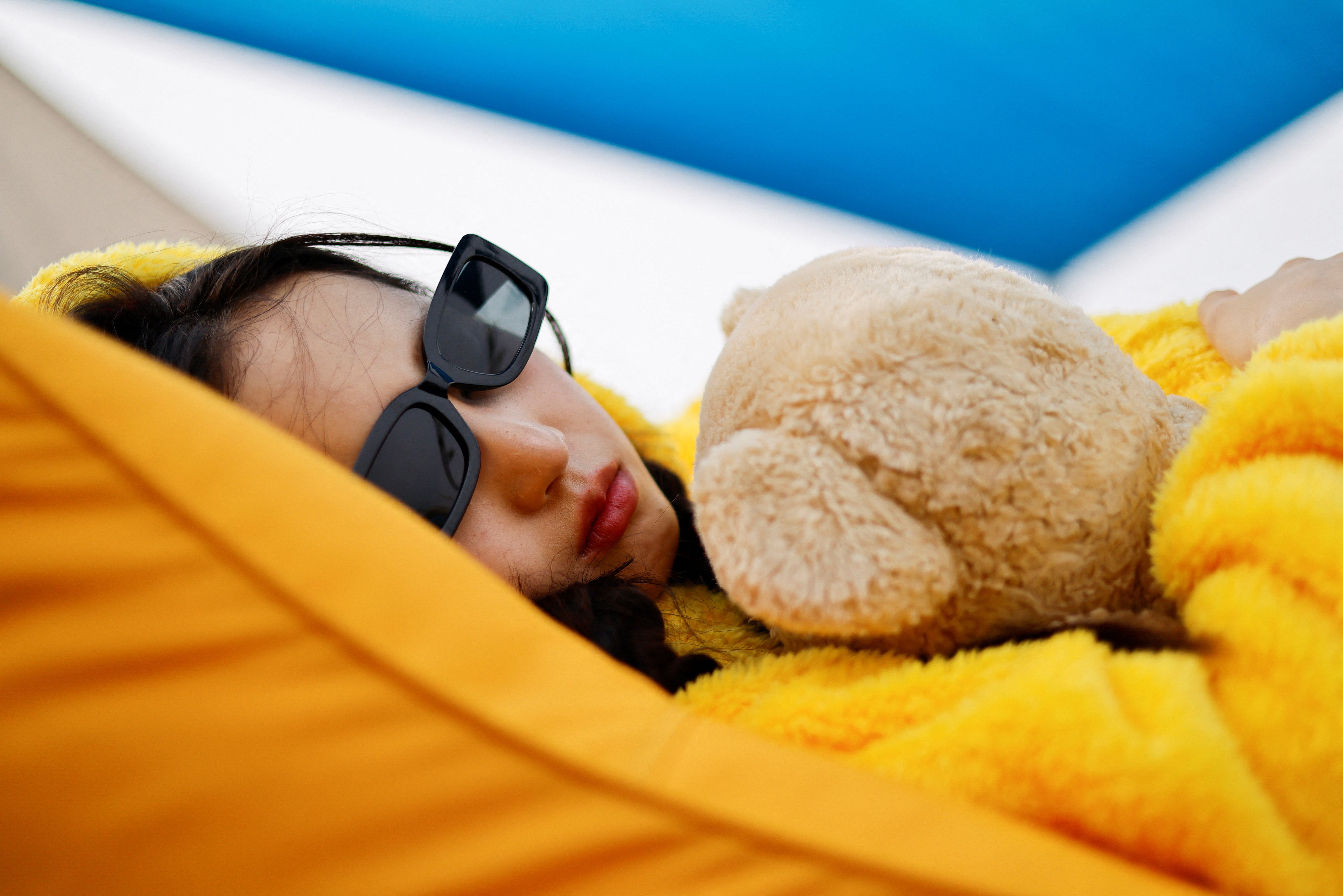 A participant sleeps during the 2026 Power Nap contest at Han River park in Seoul