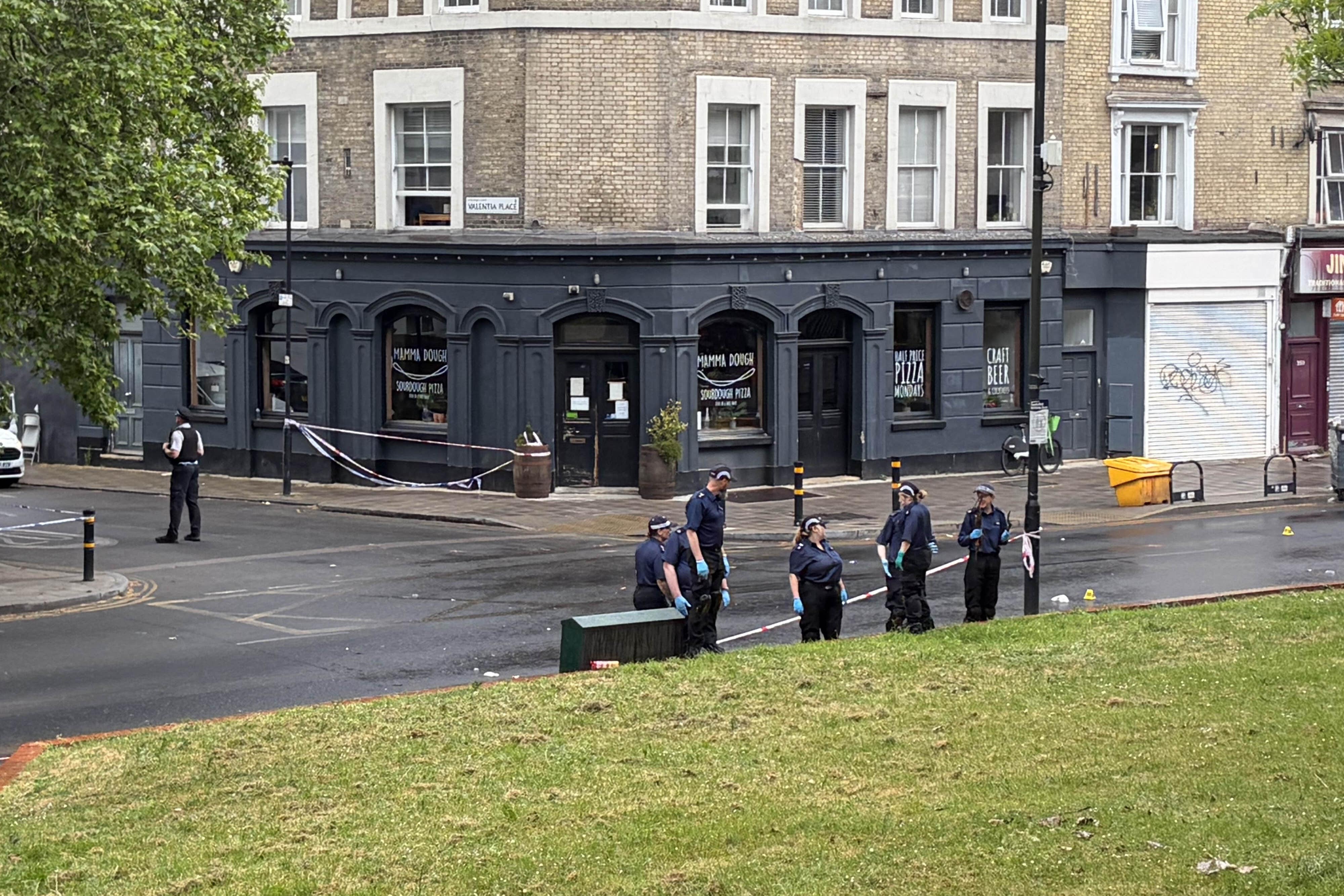 Police in Brixton searched near the scene after four people were taken to hospital with gunshot wounds (Clara Margotin/PA)
