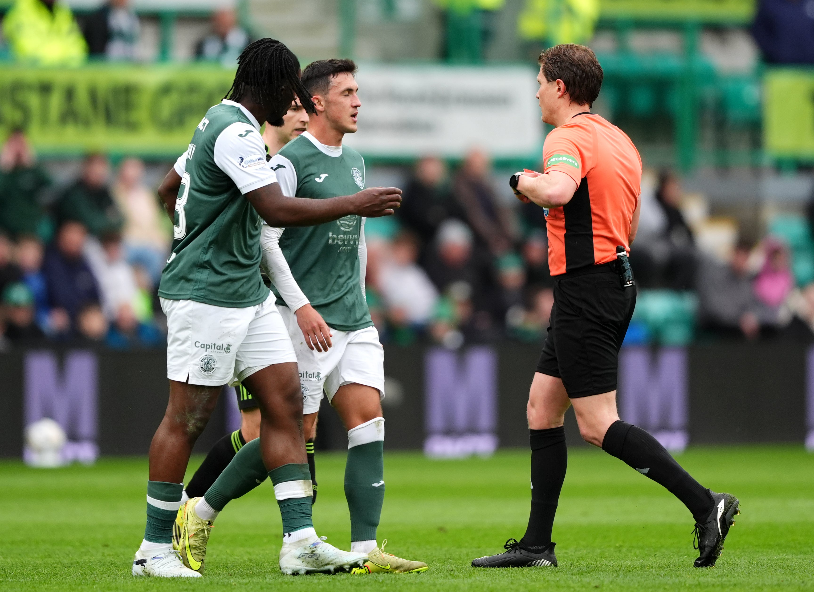 Referee David Dickinson shows a red card to Hibernian's Jamie McGrath