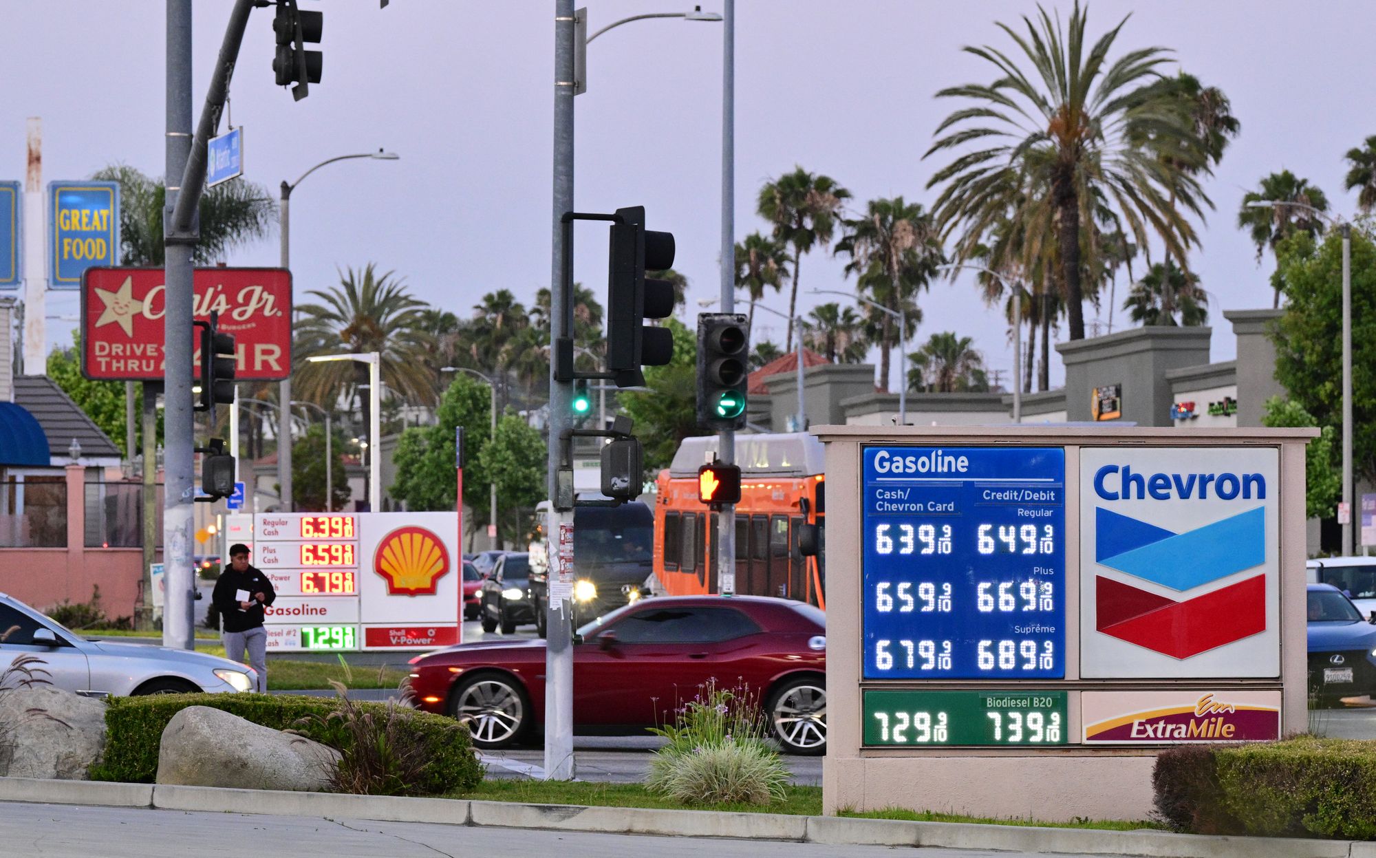 Americans are driving less and cutting back on other expenses due to rising gas prices, a new poll found