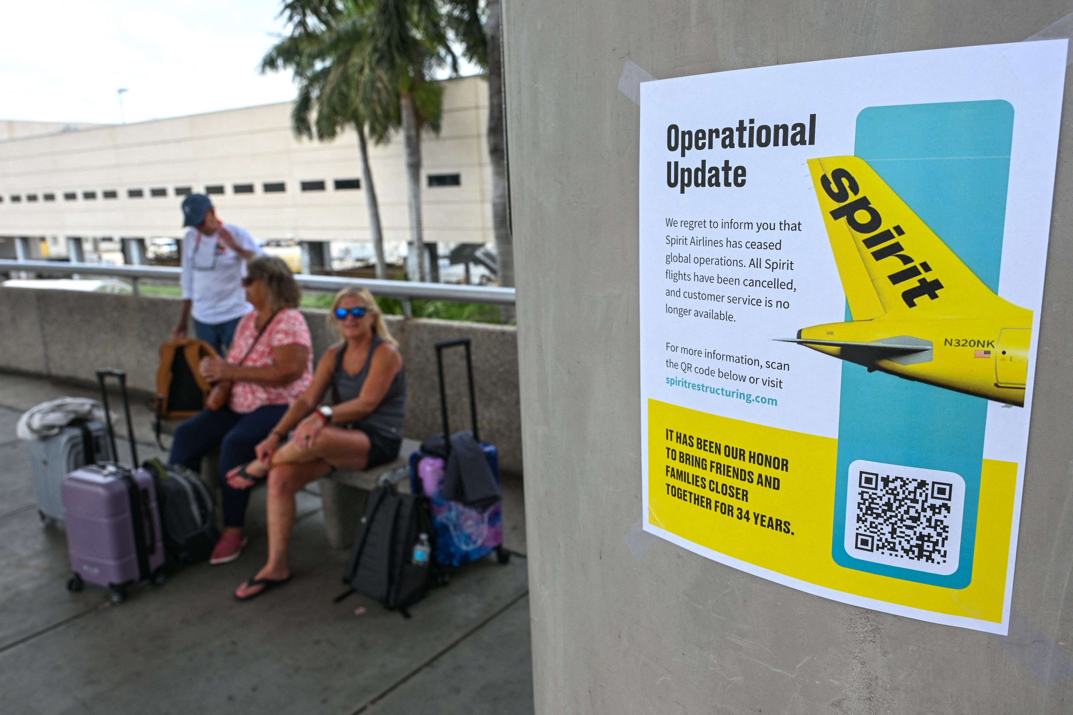 A Spirit Airlines message for customers is seen on a pamphlet after the company ceased global operations at Fort Lauderdale-Hollywood International Airport