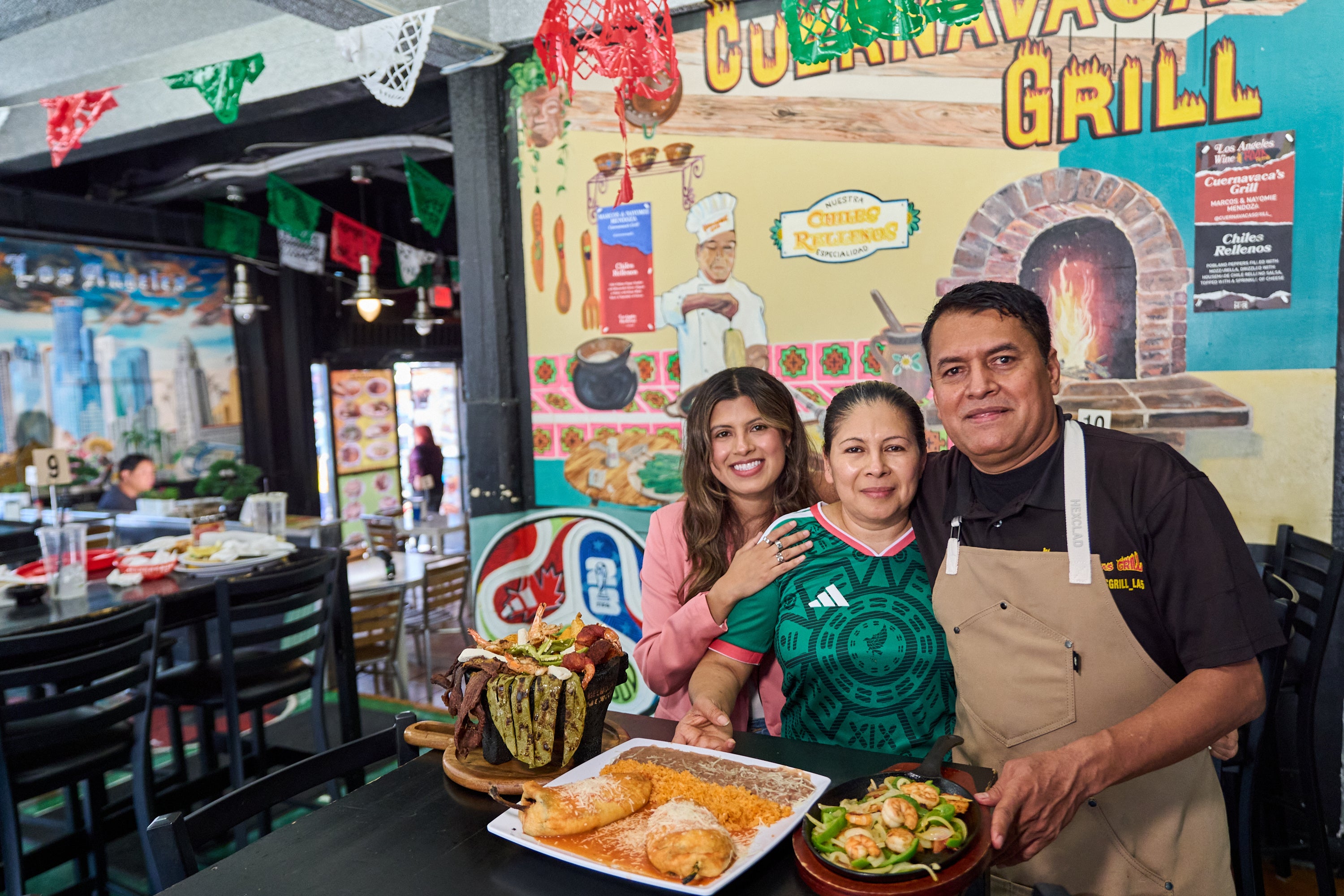 Chef Marco Mendoza, right, his wife Maria Luisa Mendoza, center, and daughter Nayomie Mendoza, pose for a picture at their Mexican restaurant Cuernavaca's Grill in downtown Los Angeles,