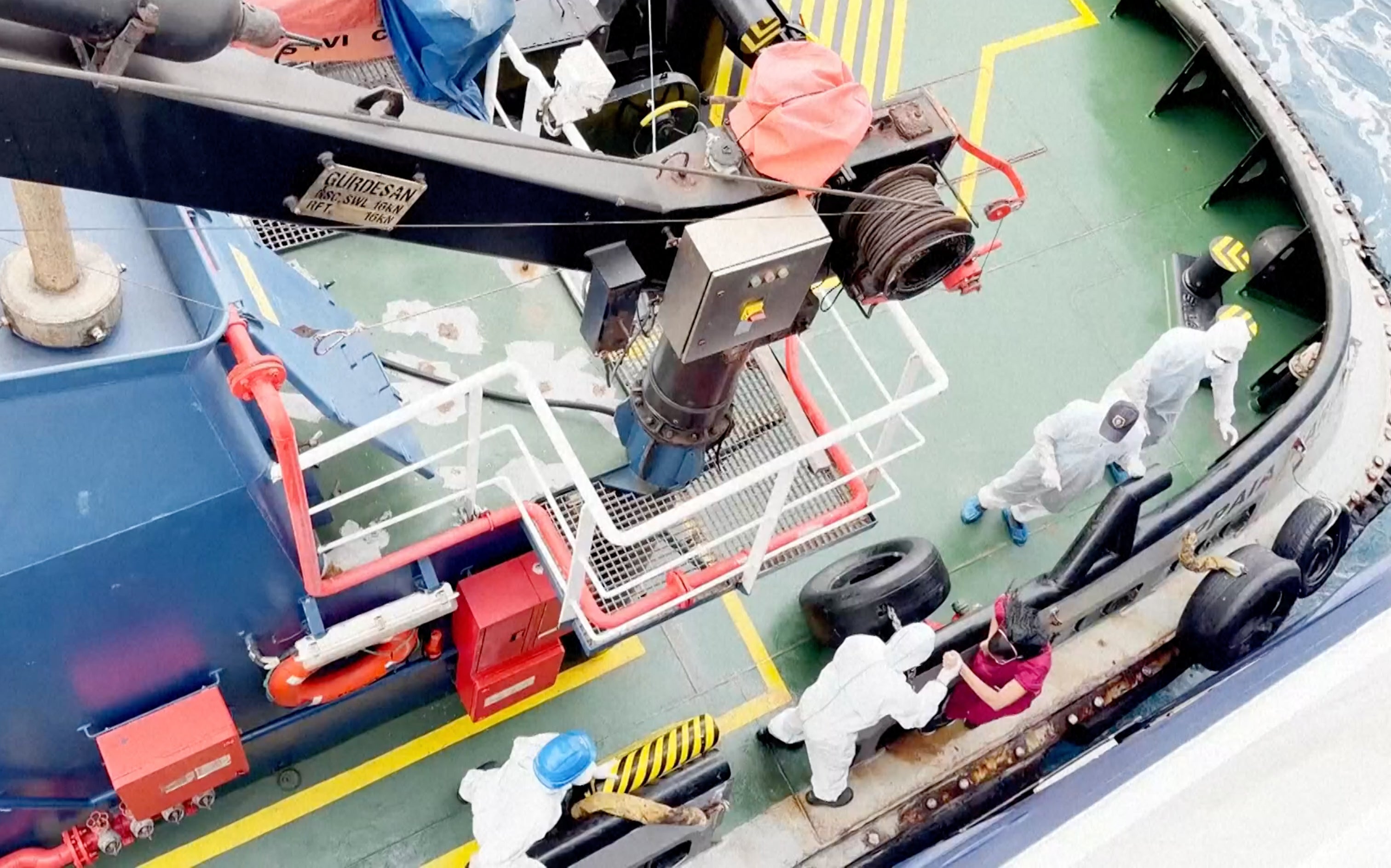 Health workers get off the Dutch-flagged MV Hondius on Monday