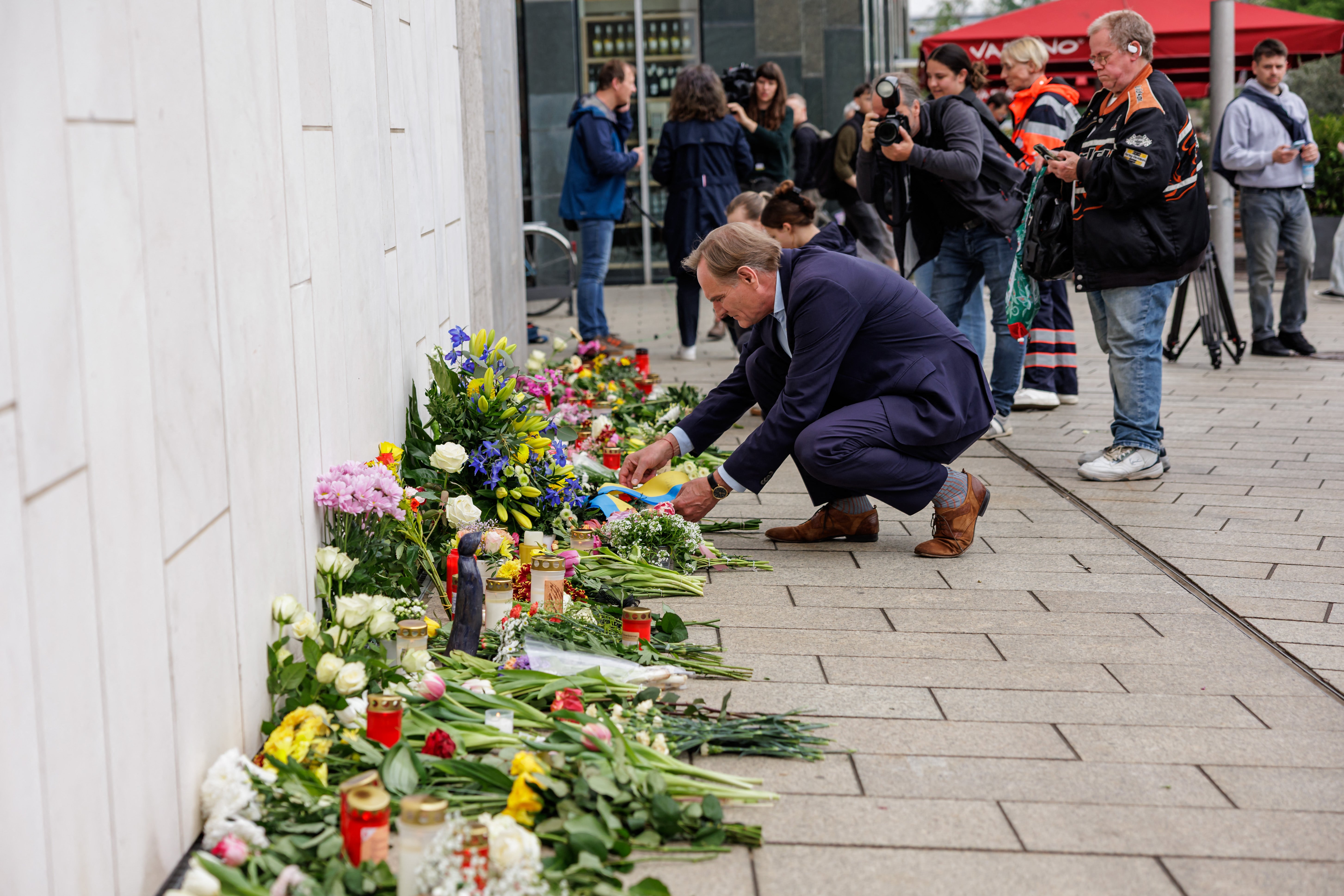 The mayor of Leipzig Burkhard Jung lays a wreath for the victims at a makeshift memorial on Tuesday