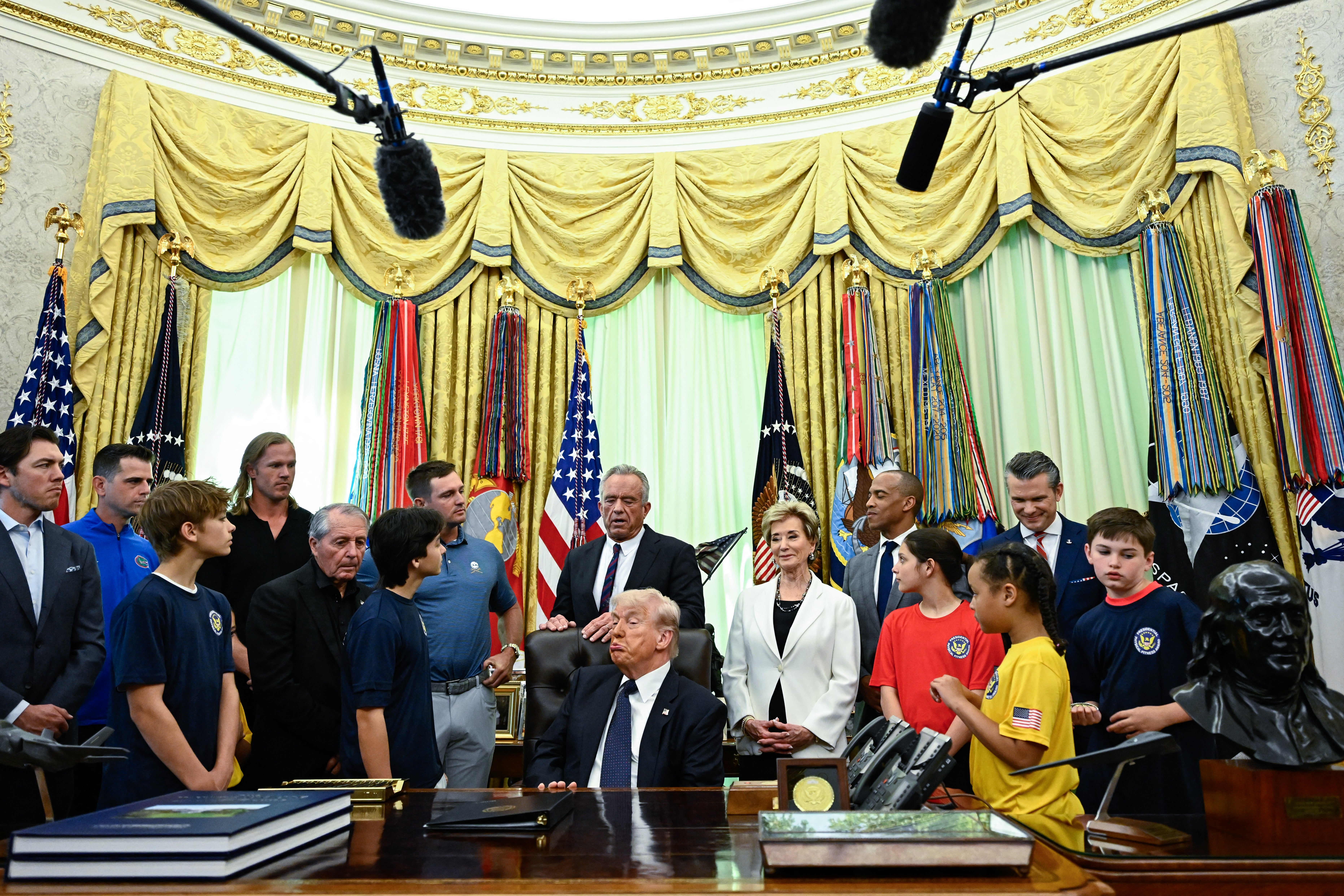 Trump surrounded by officials and students during an event to sign a proclamation restoring the Presidential Fitness Test