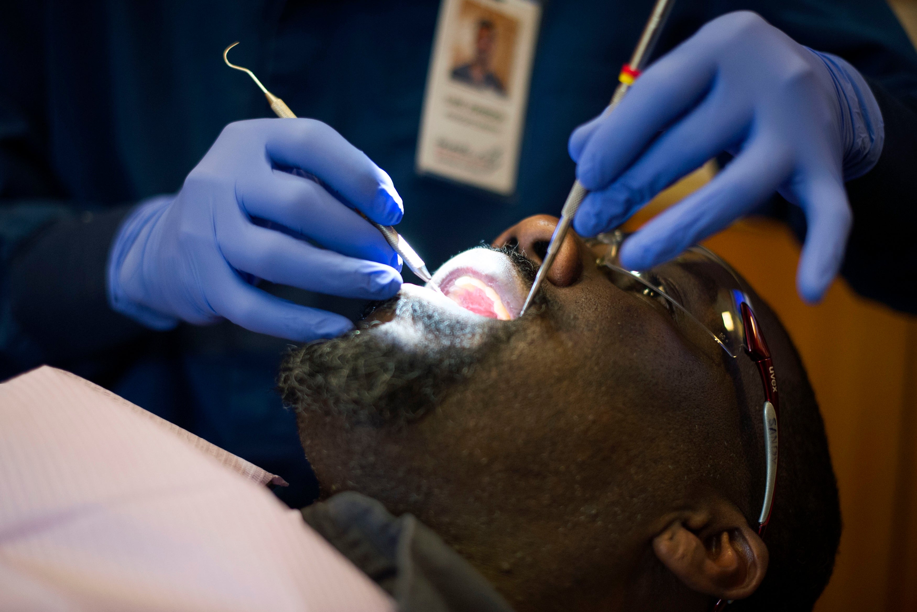 A dentist treats a patient in March 2017 in Denver, Colorado. Experts say that there are several things patients should know before they have a cavity treated
