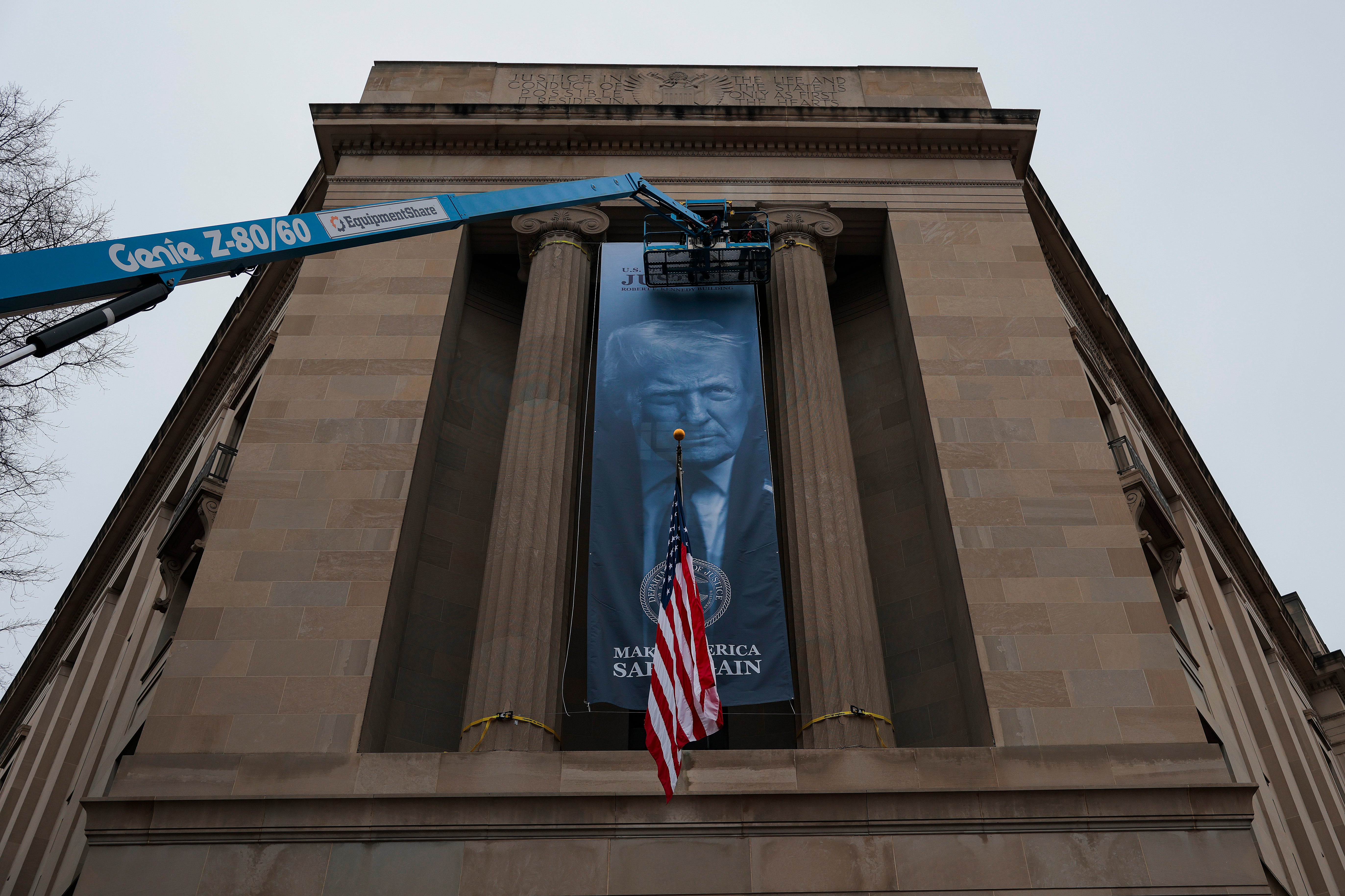 Another banner with Trump’s face that read, 'Make America Safe Again,' was hung on the facade of the Department of Justice building in Washington this past February