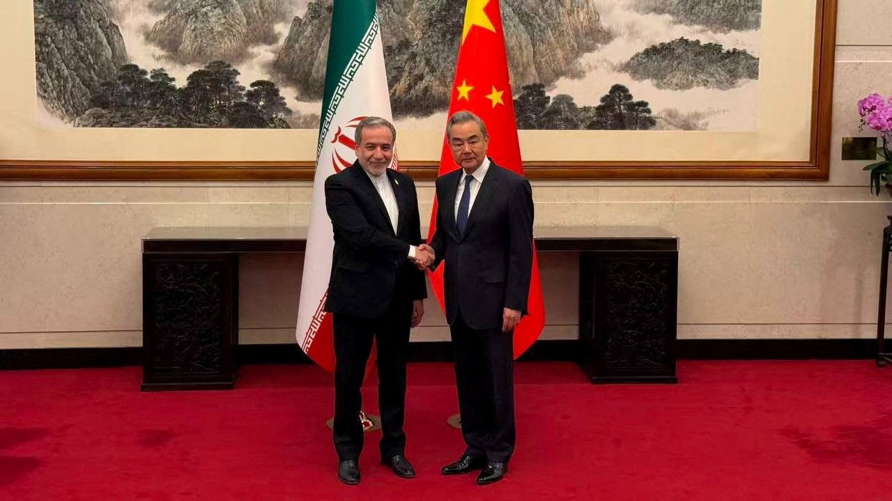 Iranian foreign minister Abbas Araqchi meets with Chinese foreign minister Wang Yi in a location given as Beijing, China, in this handout image released 6 May 2026